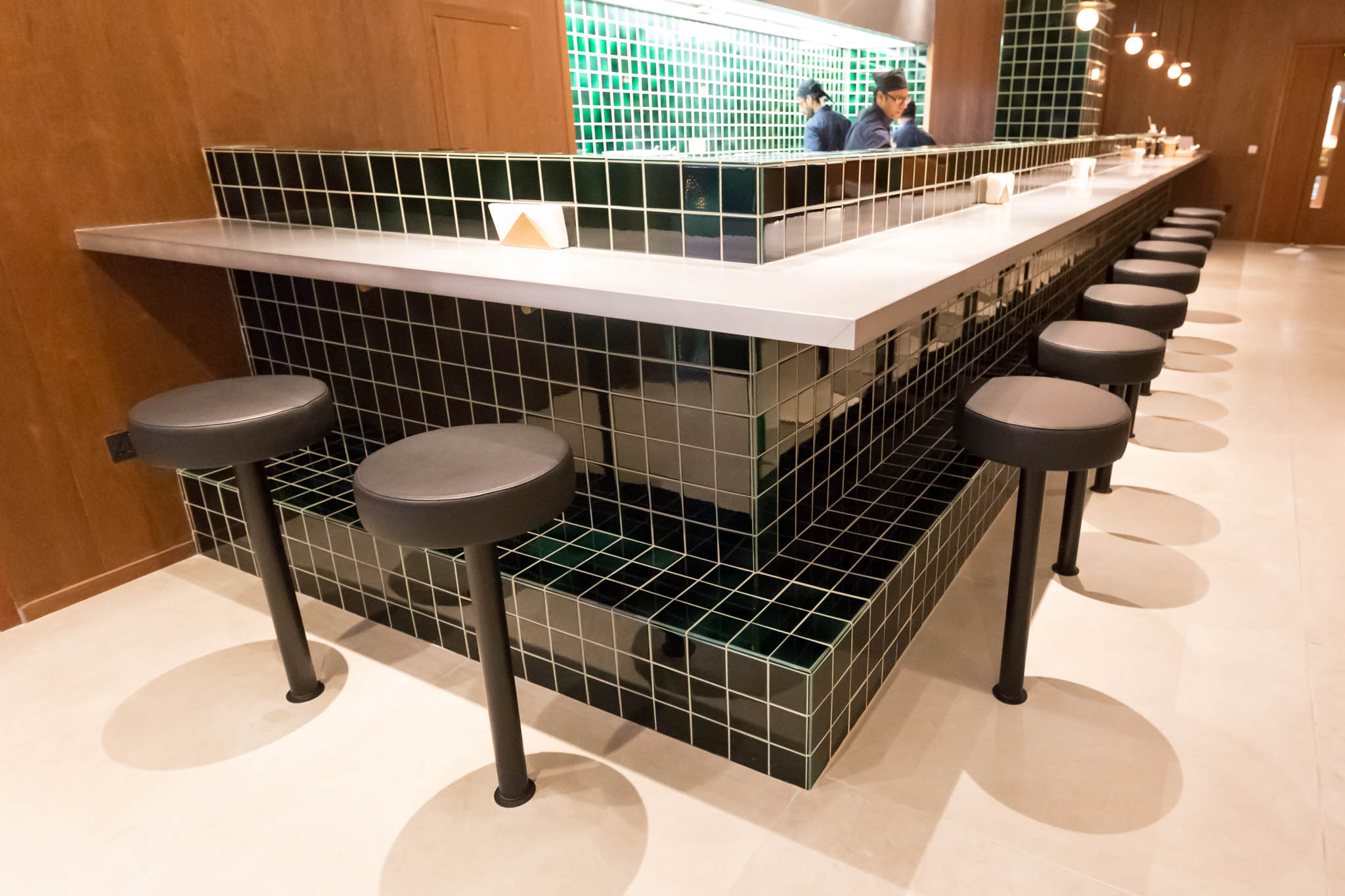 a bar with stools and a counter