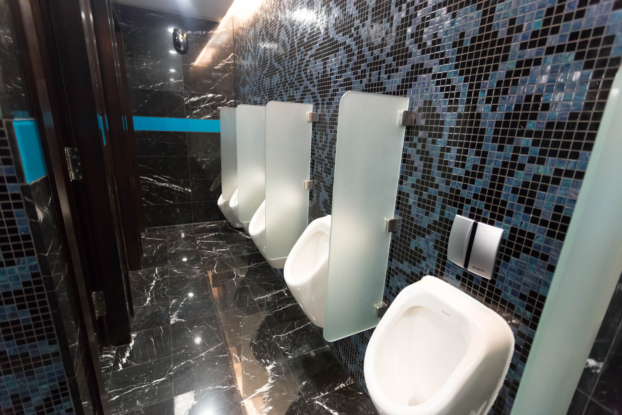 a row of urinals in a public bathroom