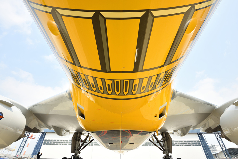 the bottom of a yellow and white airplane