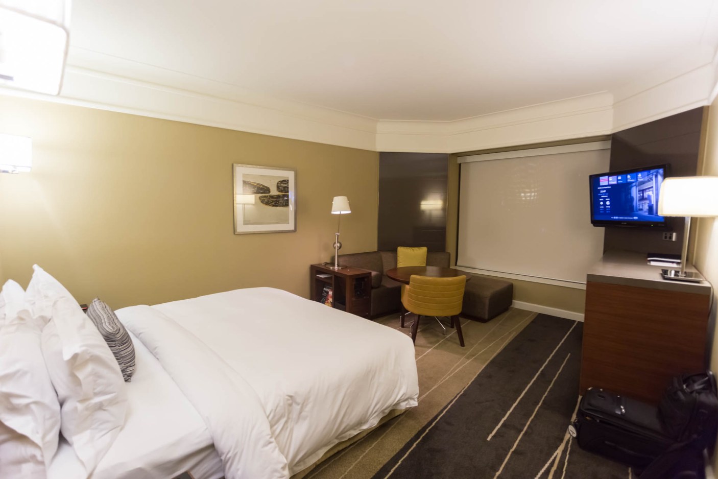 a hotel room with a bed and a tv