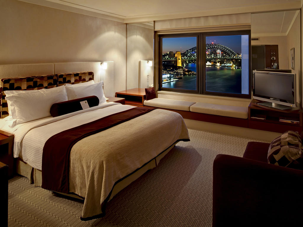 a bedroom with a large window and a bridge in the background