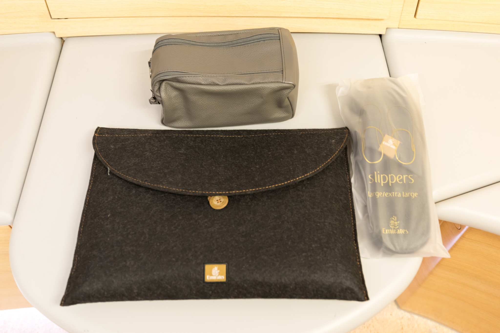 a black bag and a grey pouch on a white surface