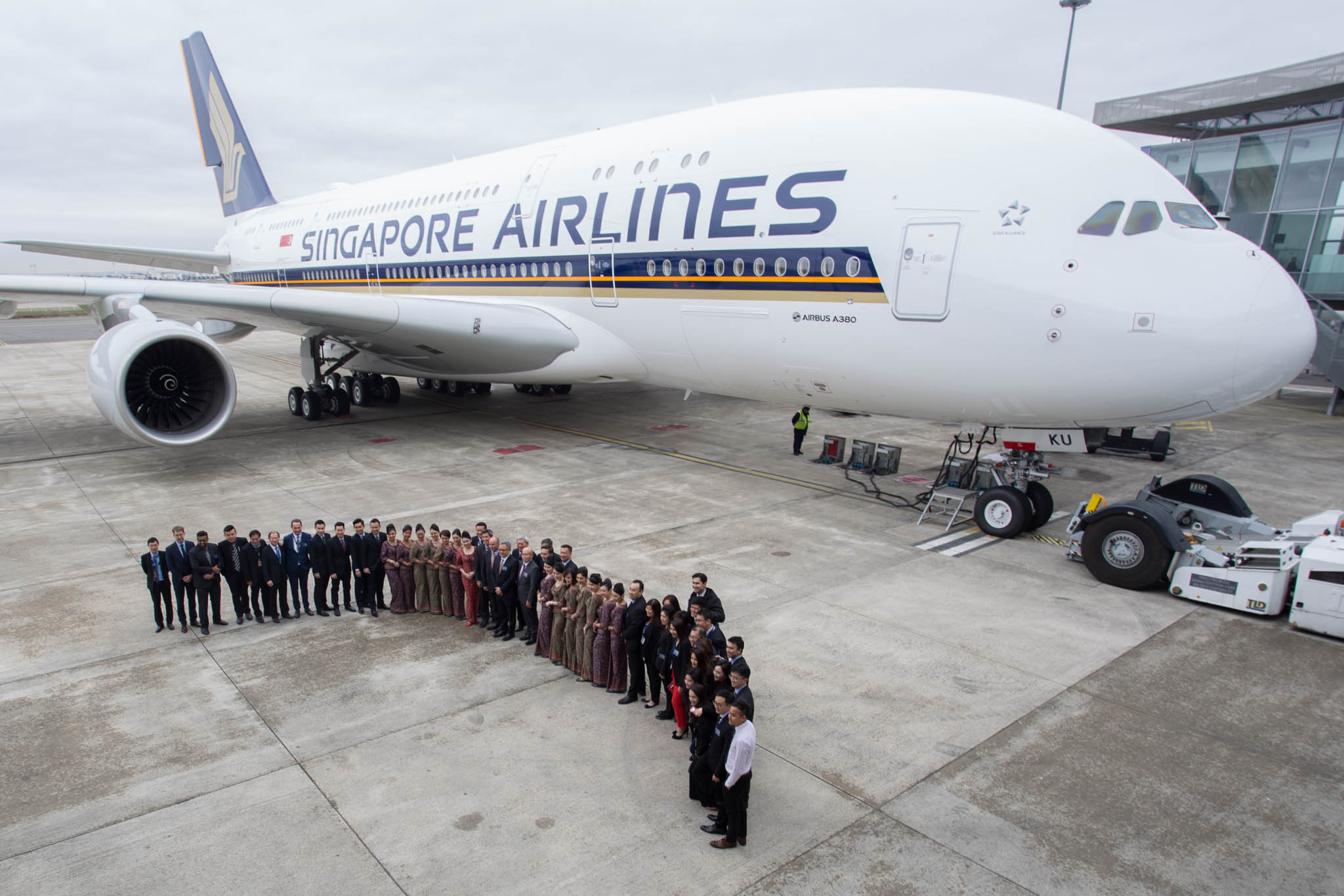 a group of people standing in front of a large airplane