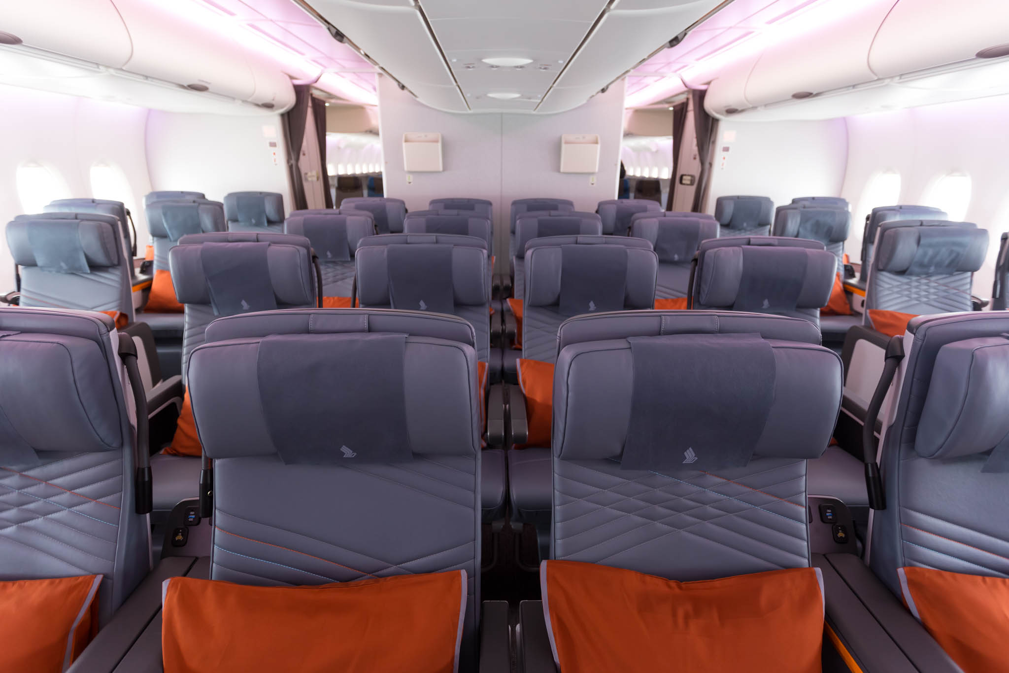 an airplane with seats and a pink light