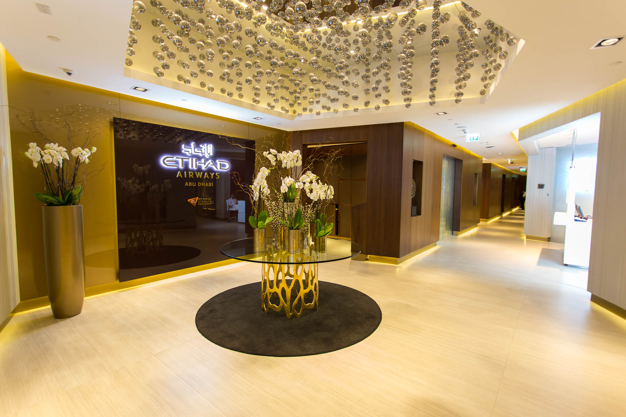 a lobby with a glass table with flowers