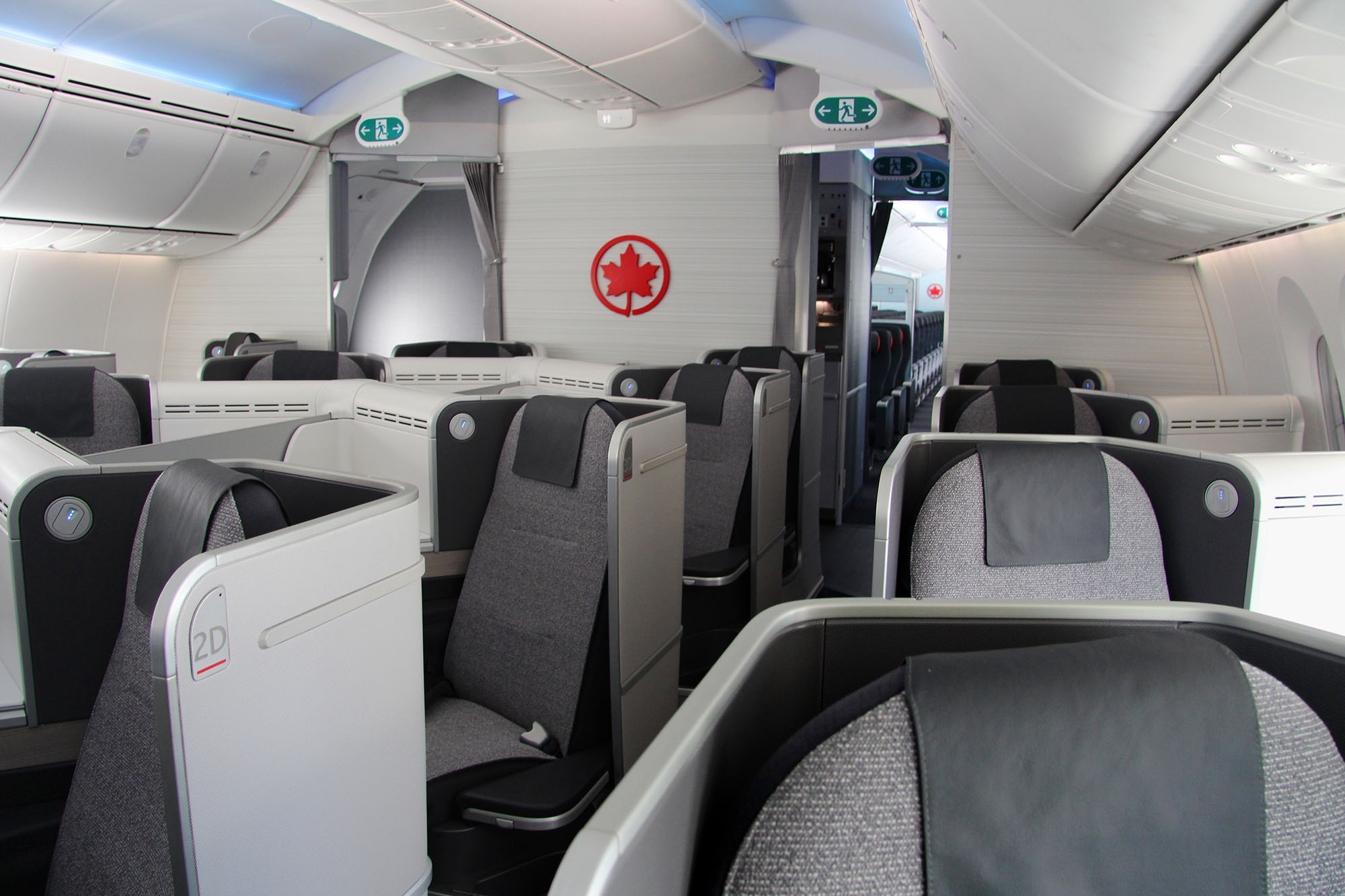 a plane with seats and a sign on the wall