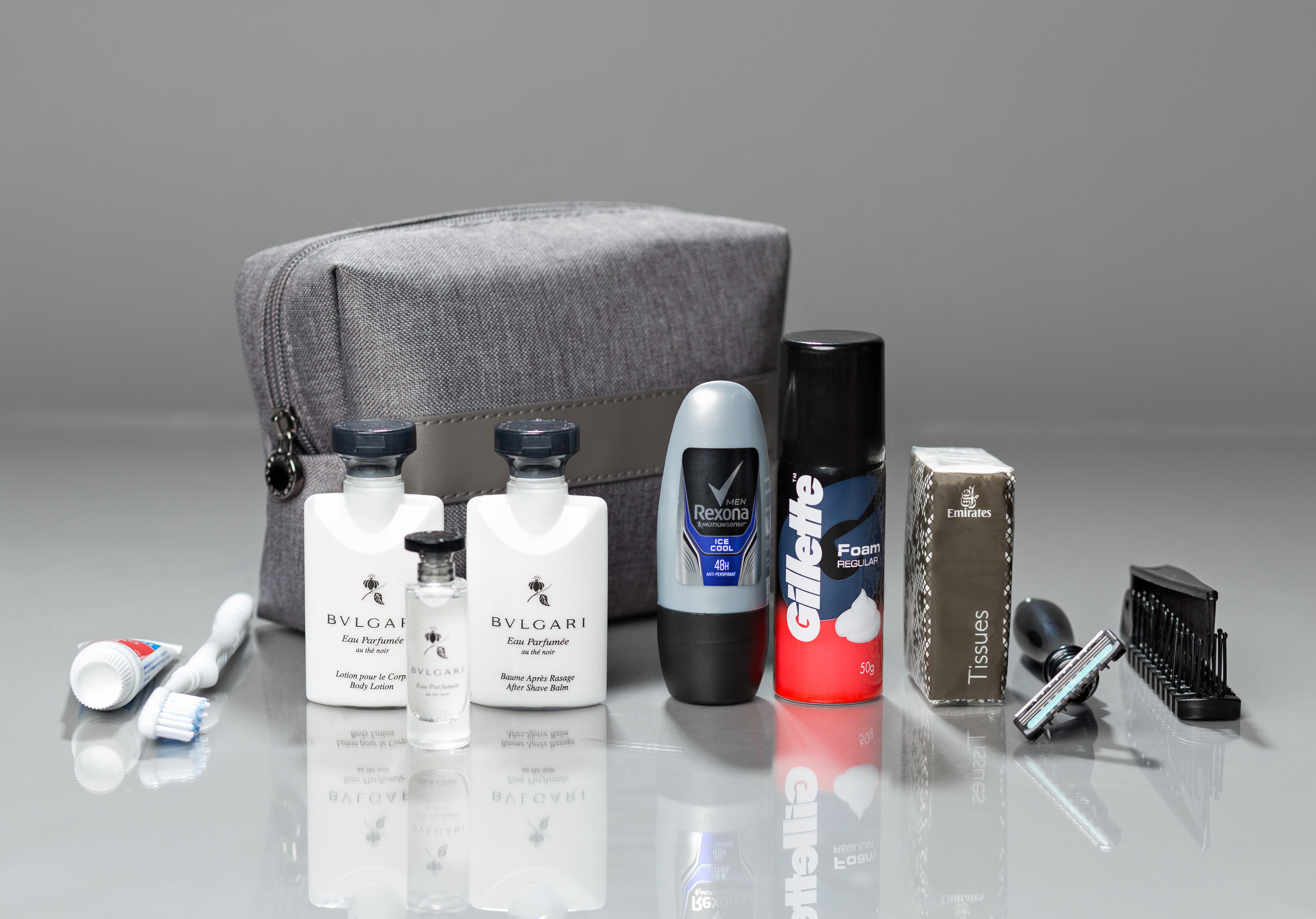 a group of personal care products next to a small bag