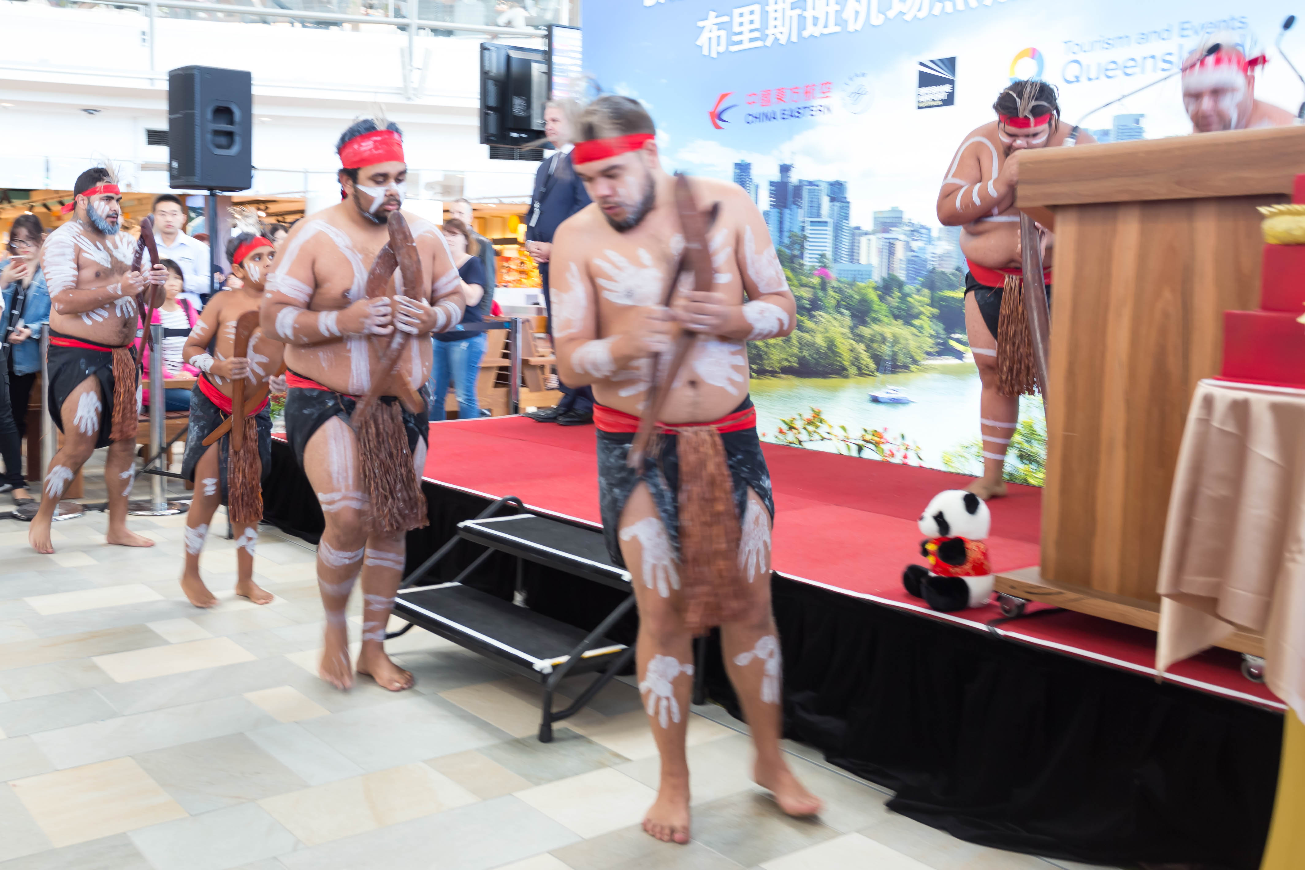a group of men with painted skin and a bow