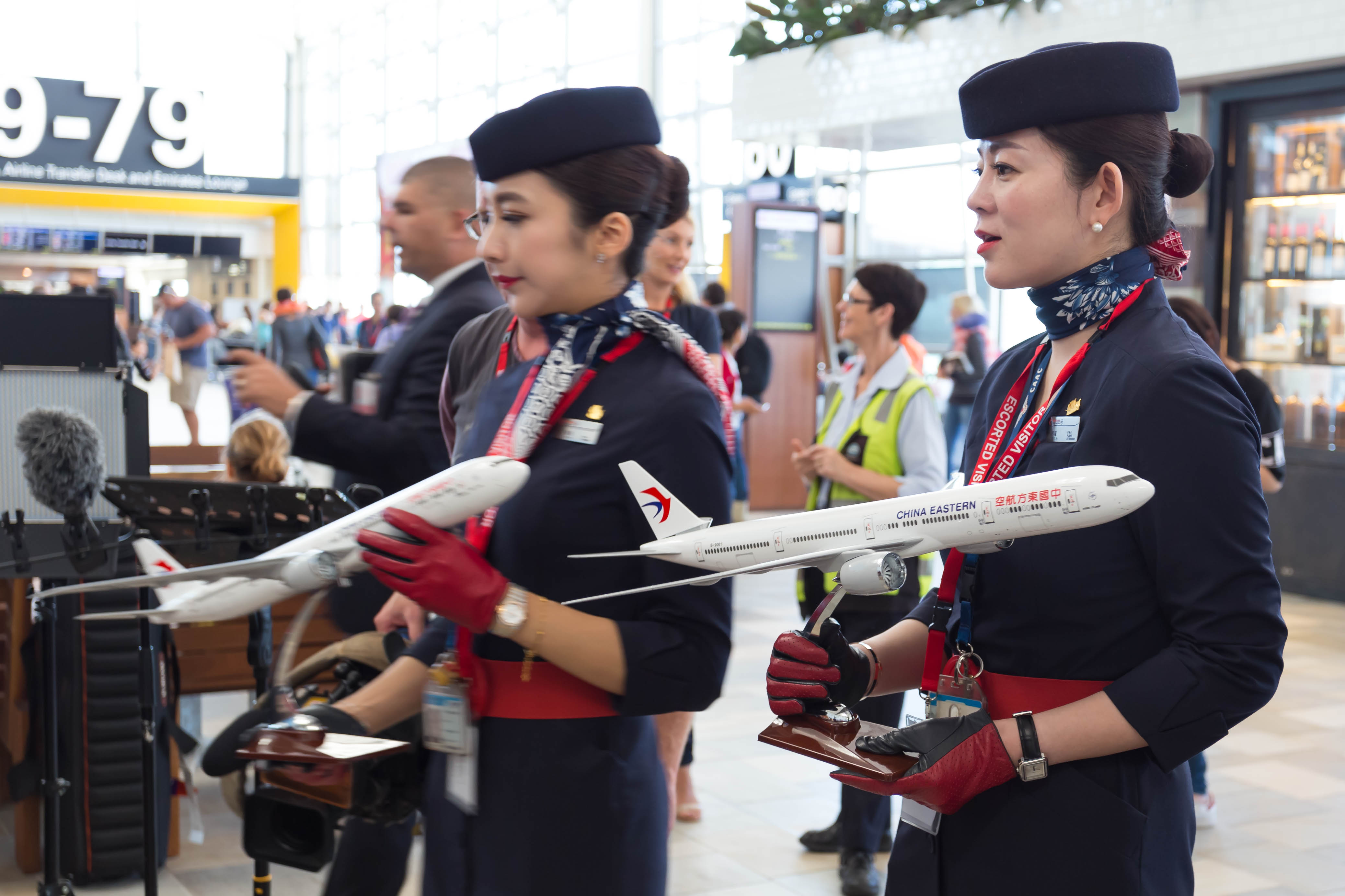 a group of women in uniform holding model airplanes