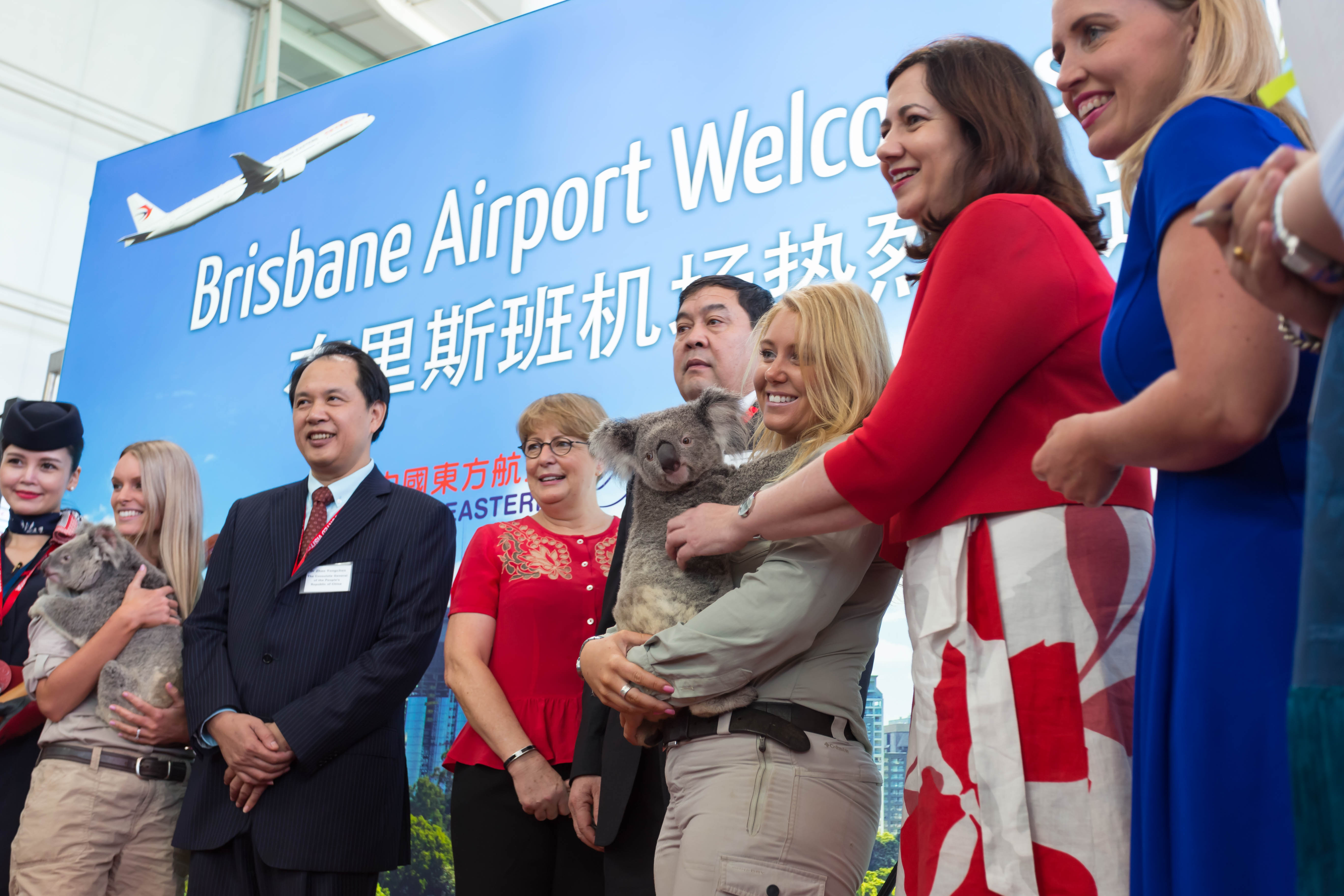 a group of people standing in front of a sign