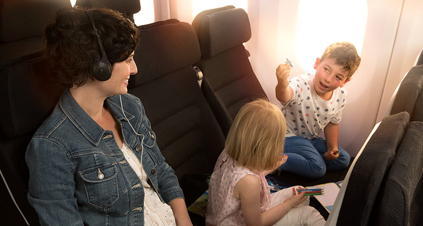 a woman and two children in an airplane