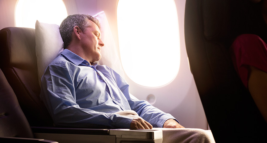 a man sleeping on an airplane