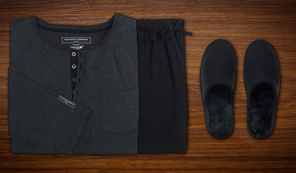 a pair of black slippers and a grey shirt