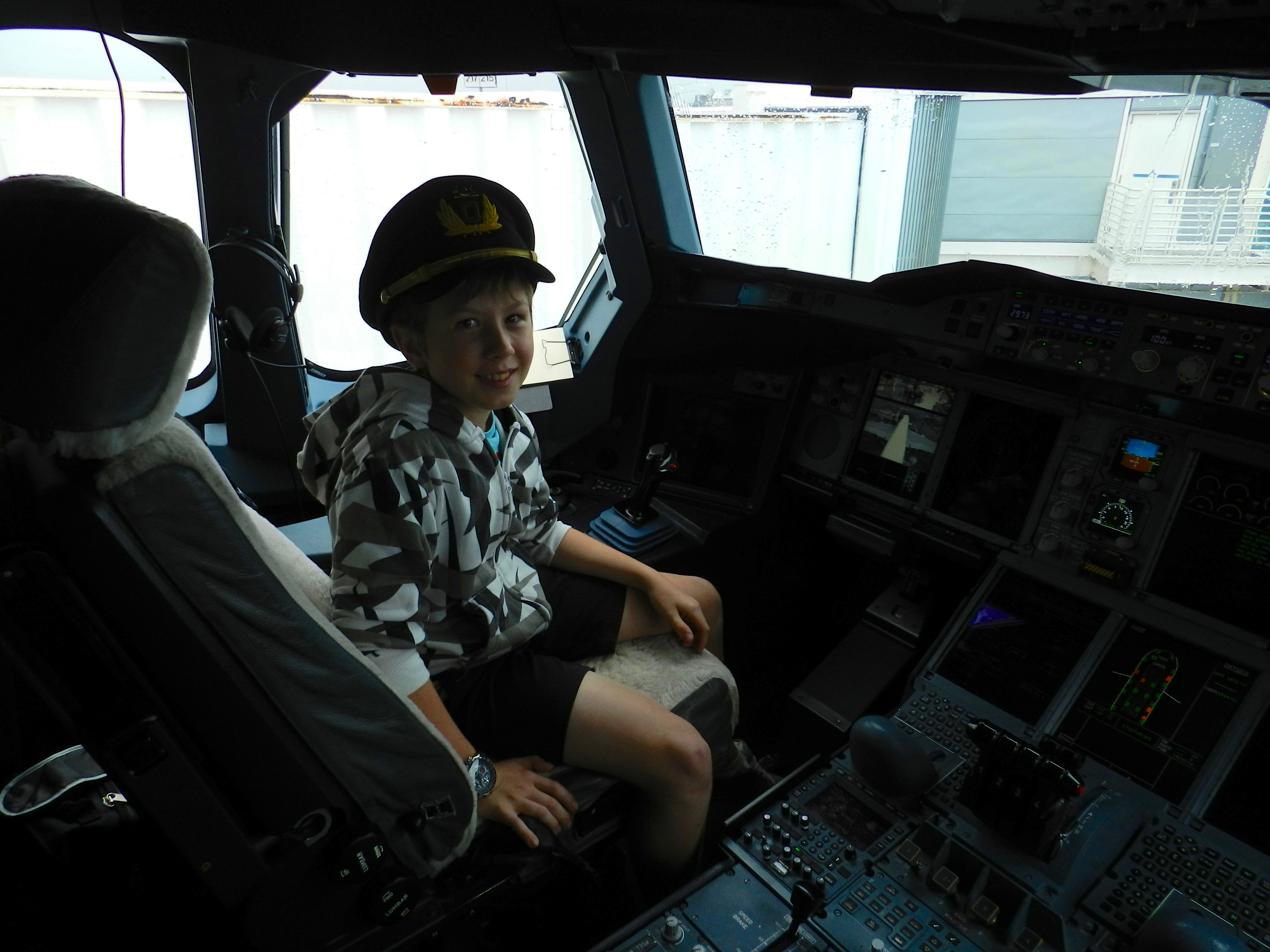a boy in a pilot's seat