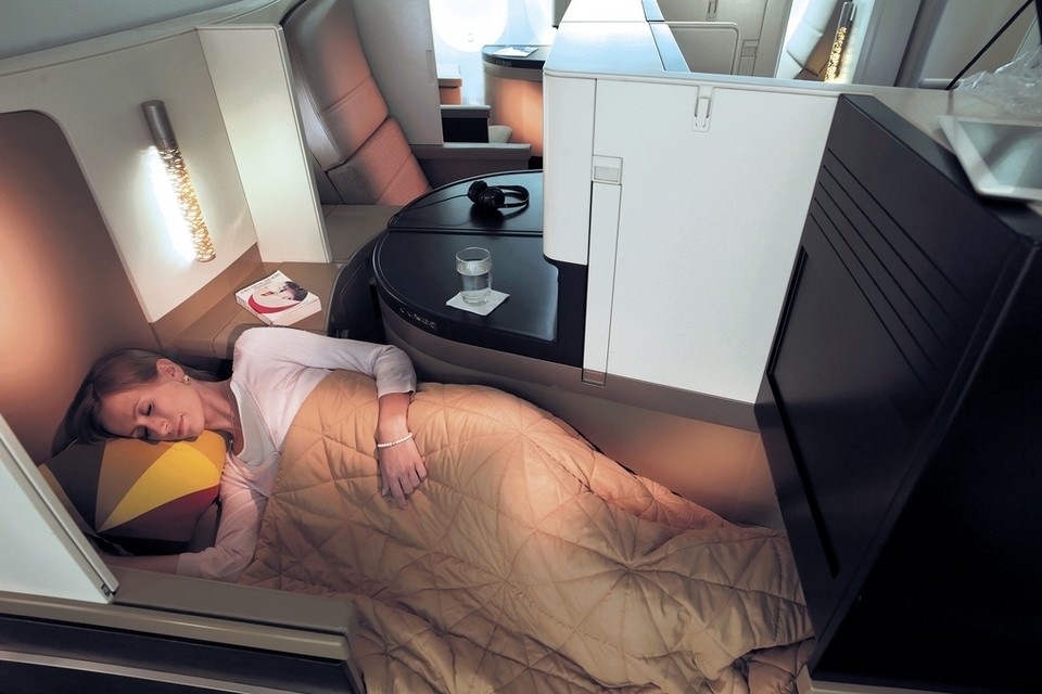 a woman sleeping in a plane