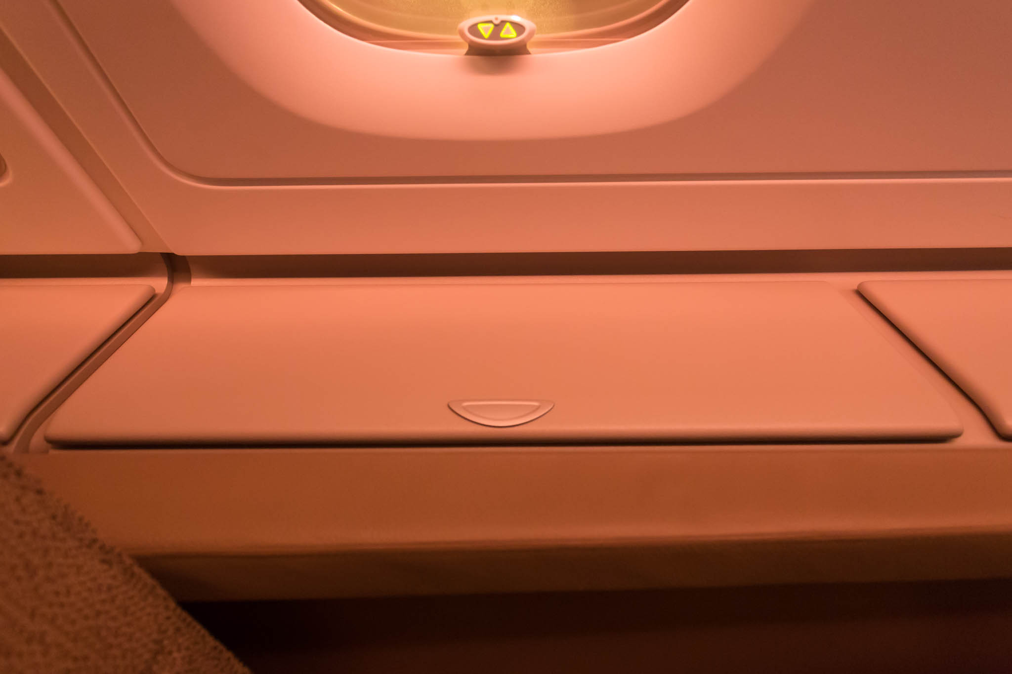 an airplane seat with a light on the side