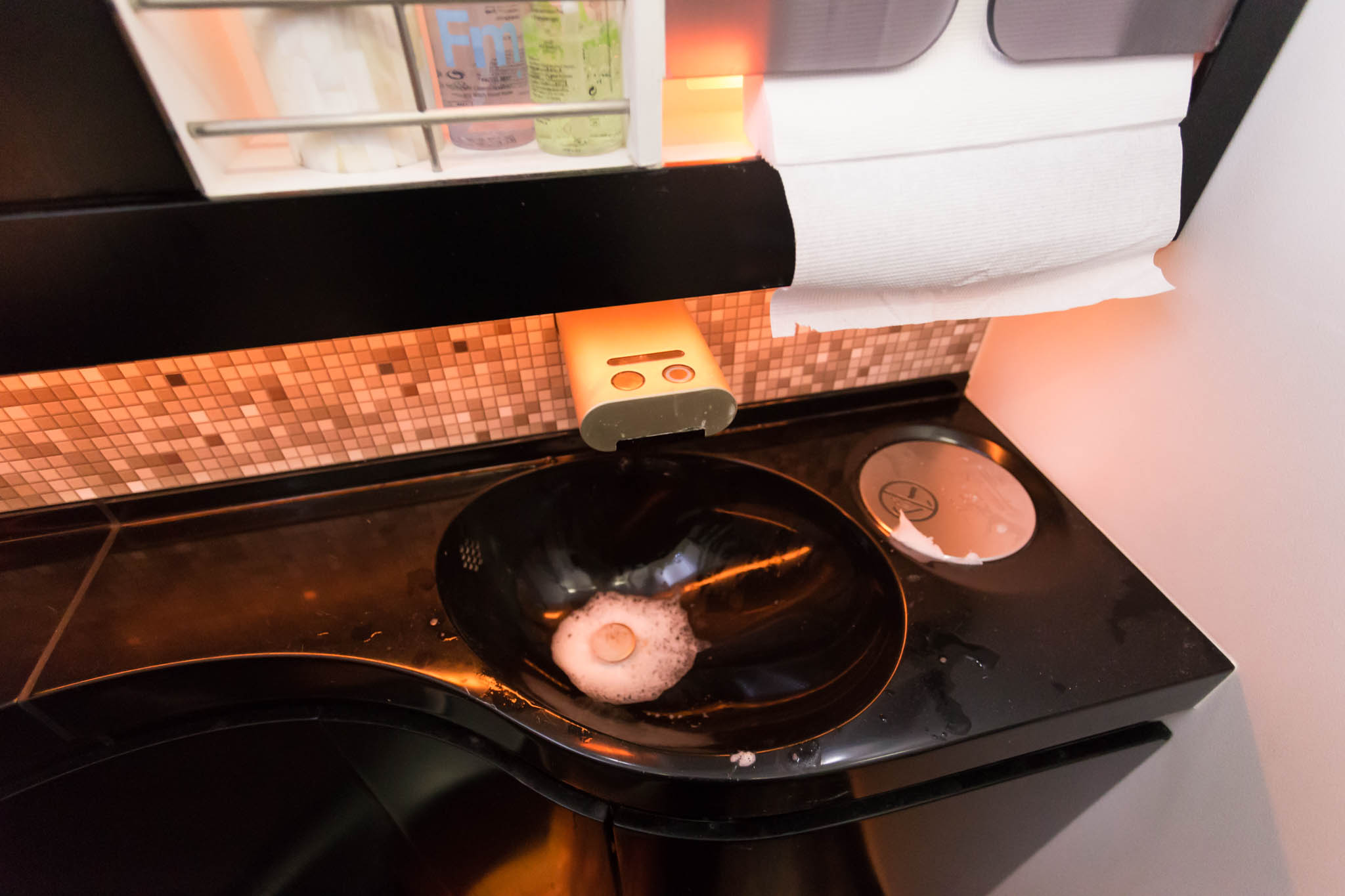 a sink with a soap dispenser