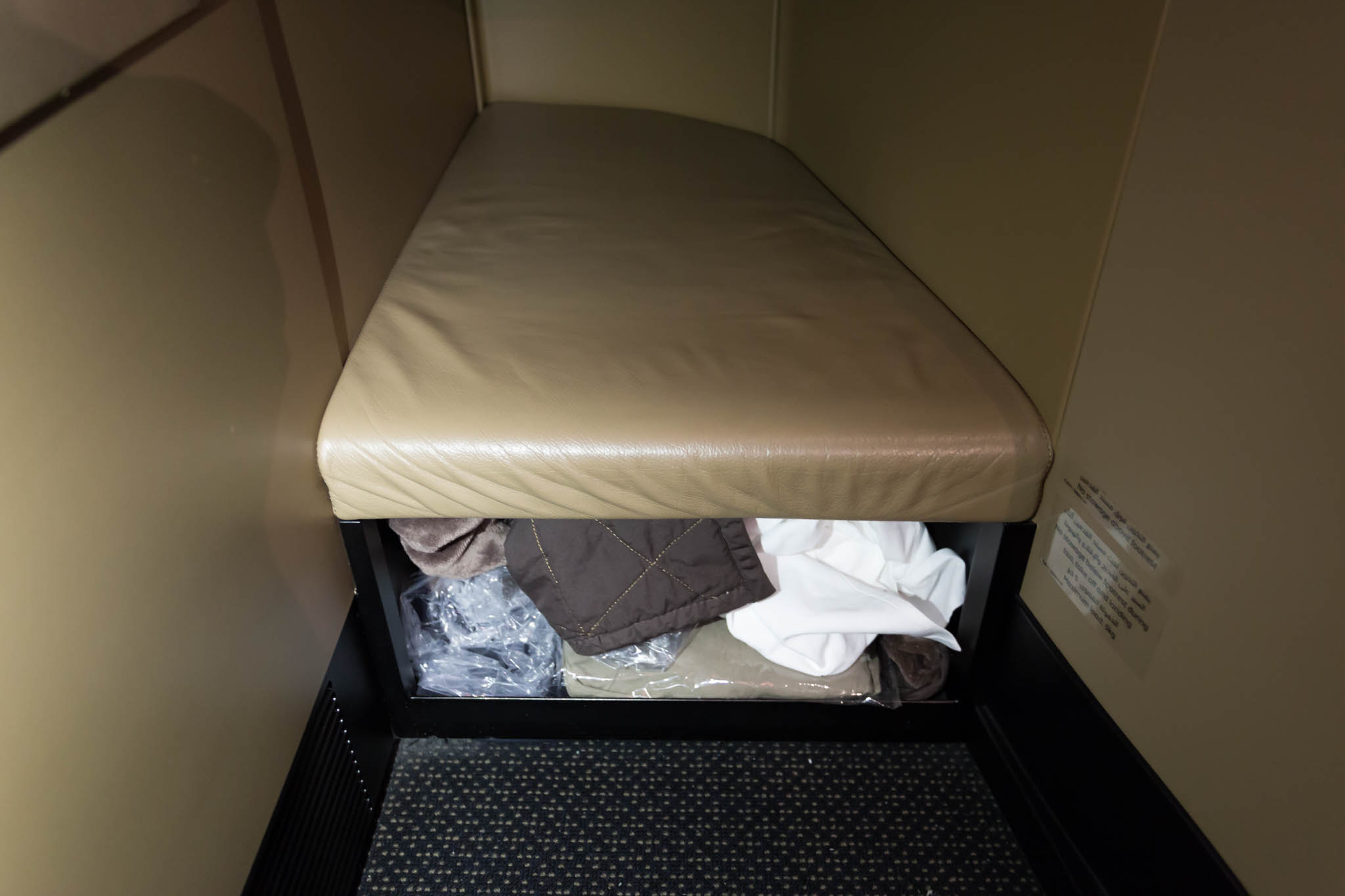 a cushioned seat with a blanket inside