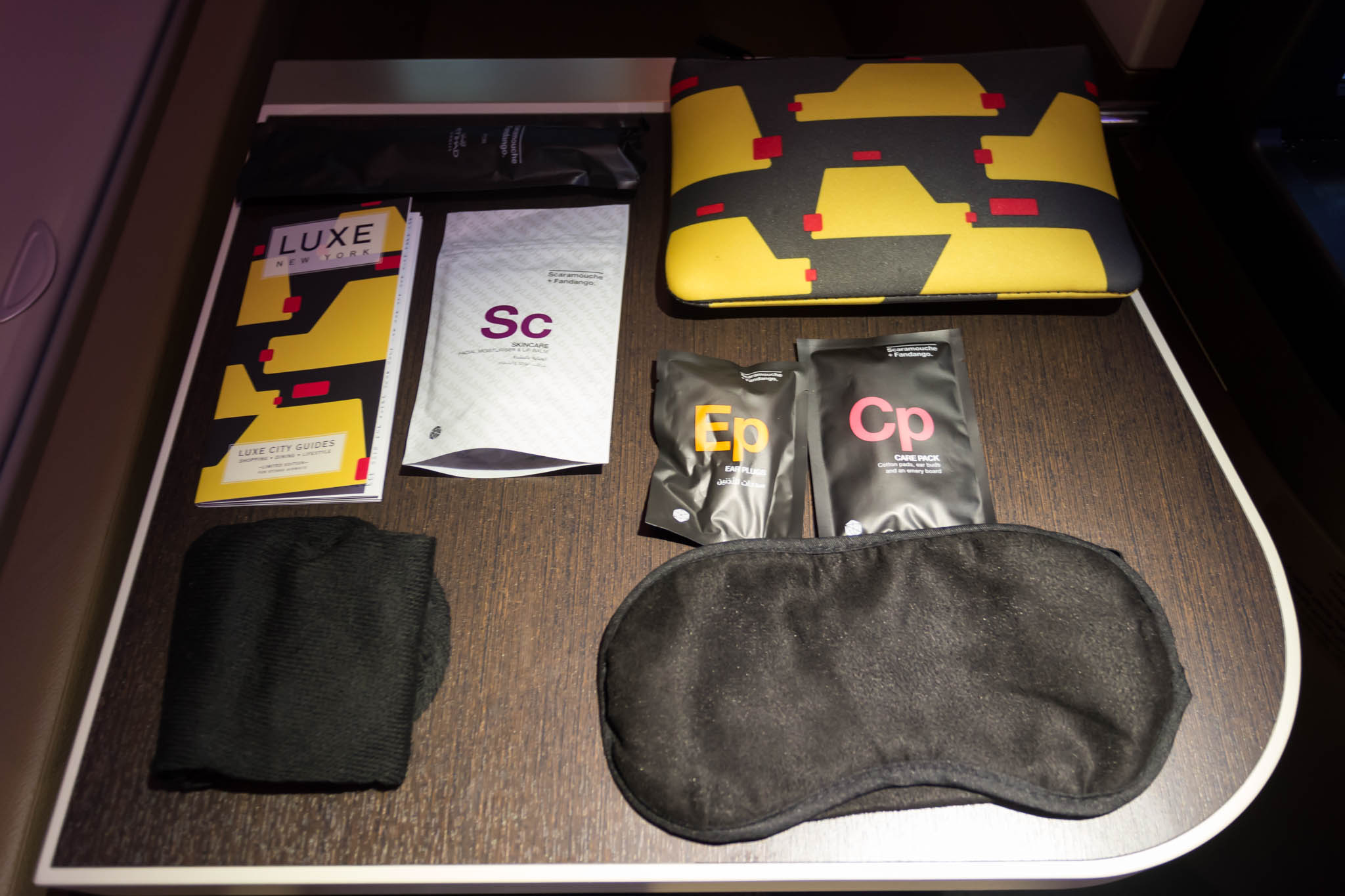 a table with a black and yellow object and a mask
