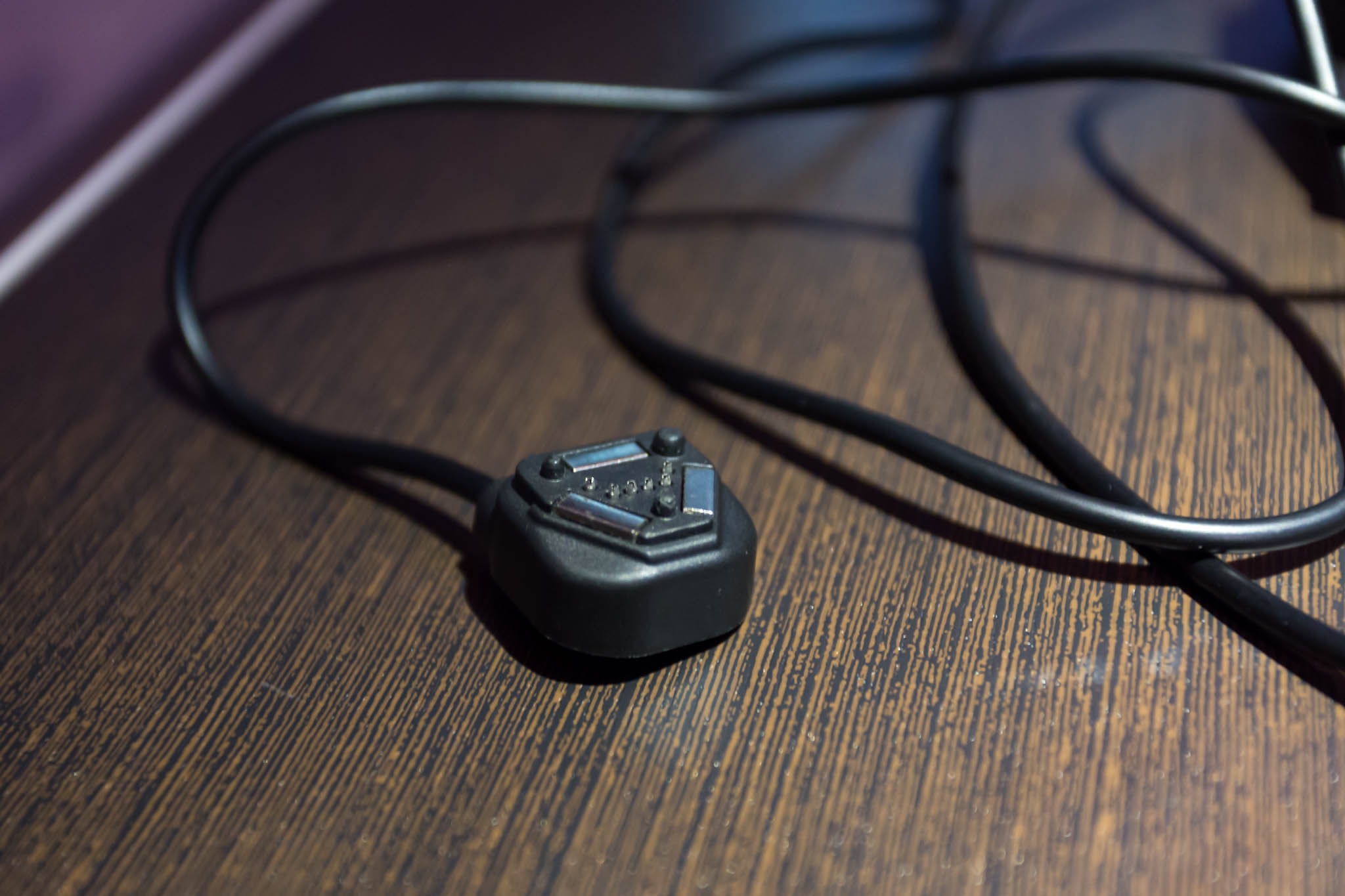 a black plug on a wood surface