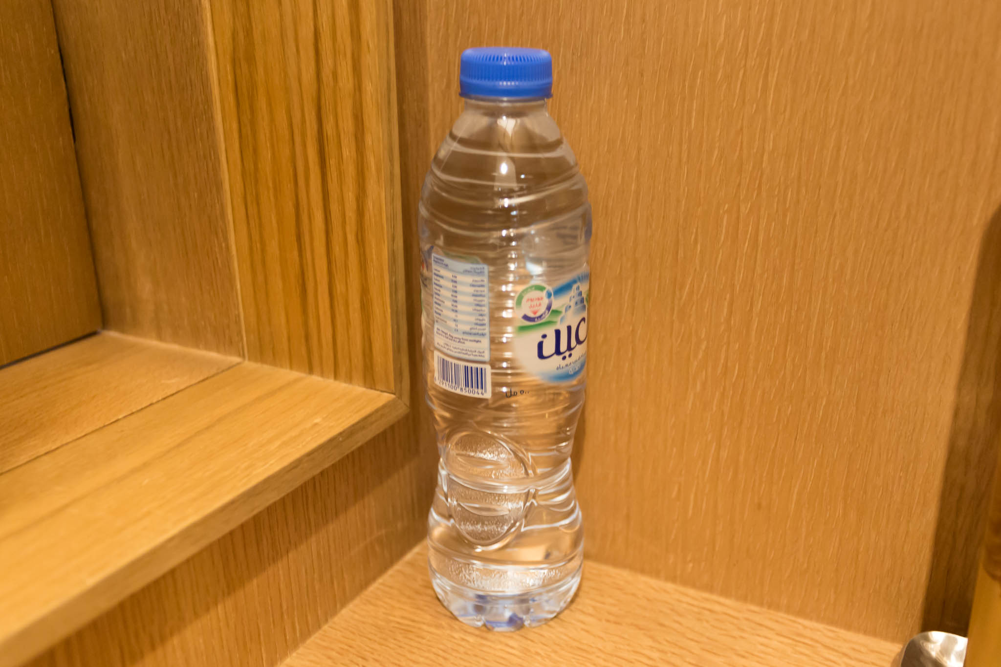 a bottle of water on a shelf