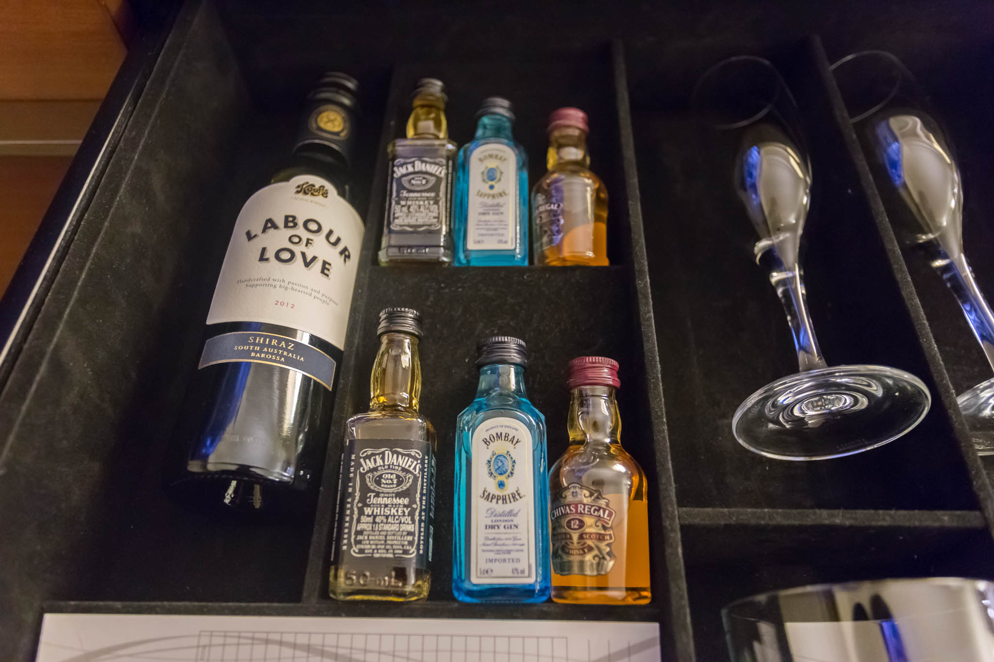 a box with bottles and a glass