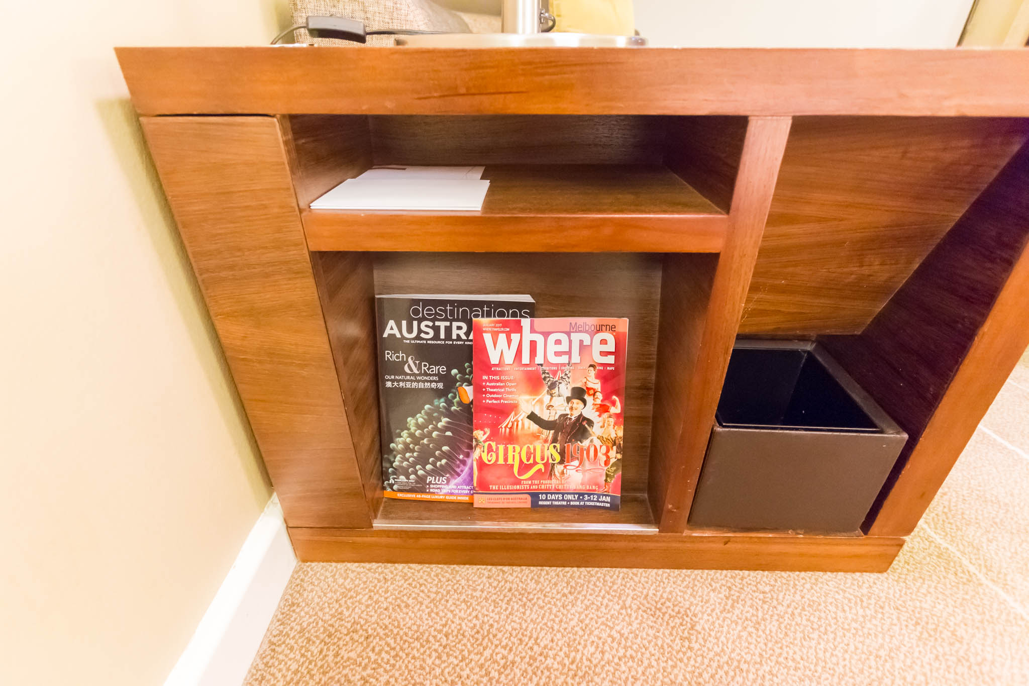 a shelf with magazines and a book in it