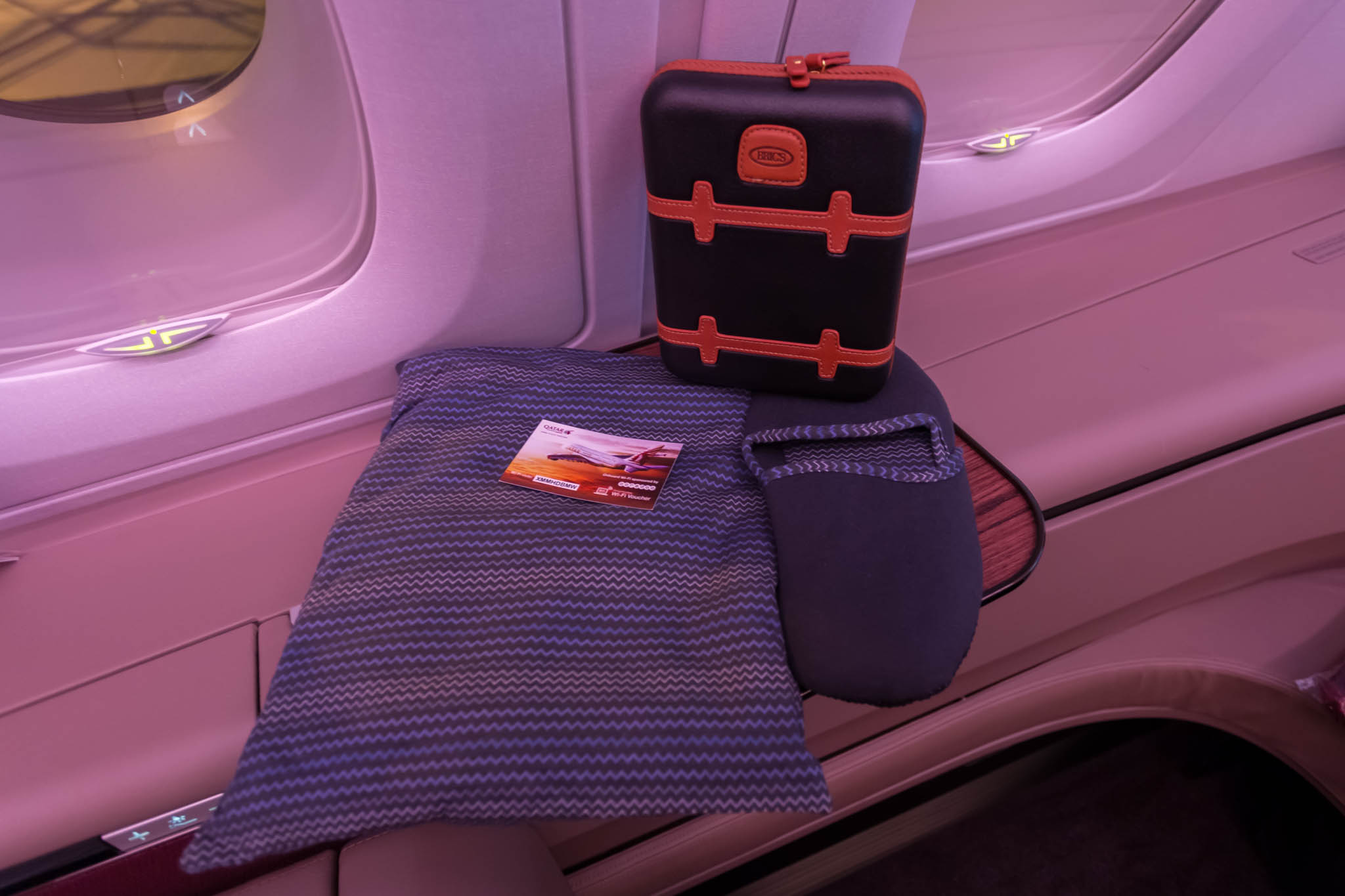a bag and a pillow on a seat