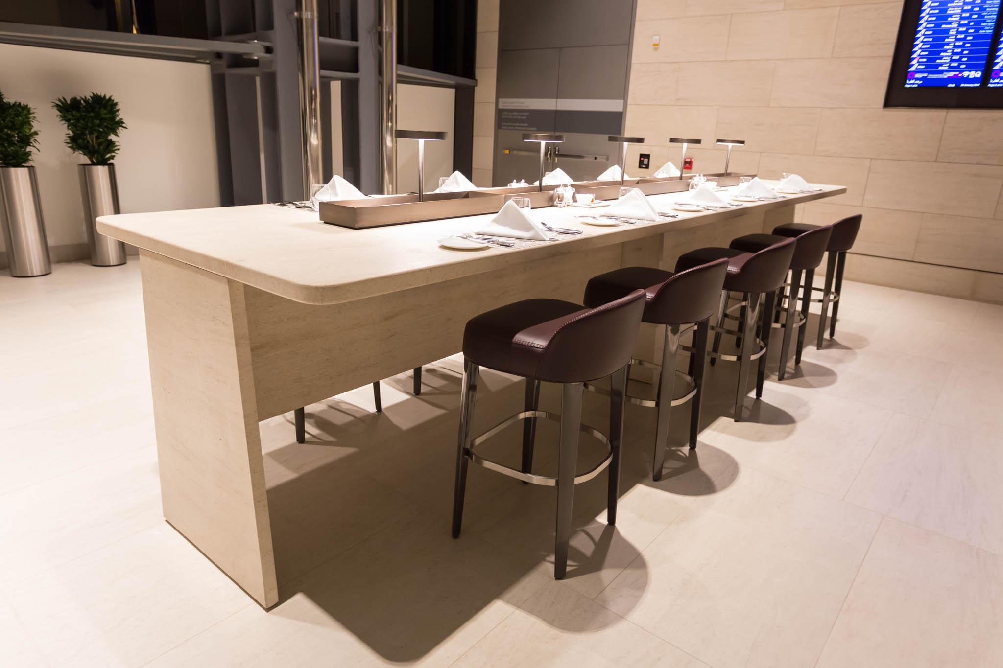 a long table with chairs and napkins