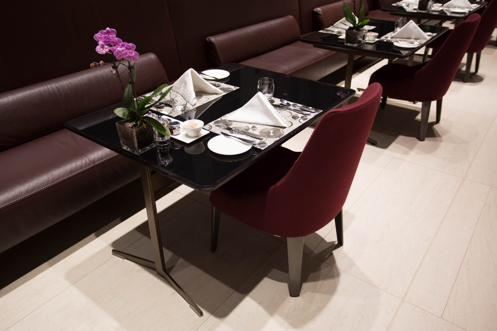 a table set up with a flower and a vase of flowers