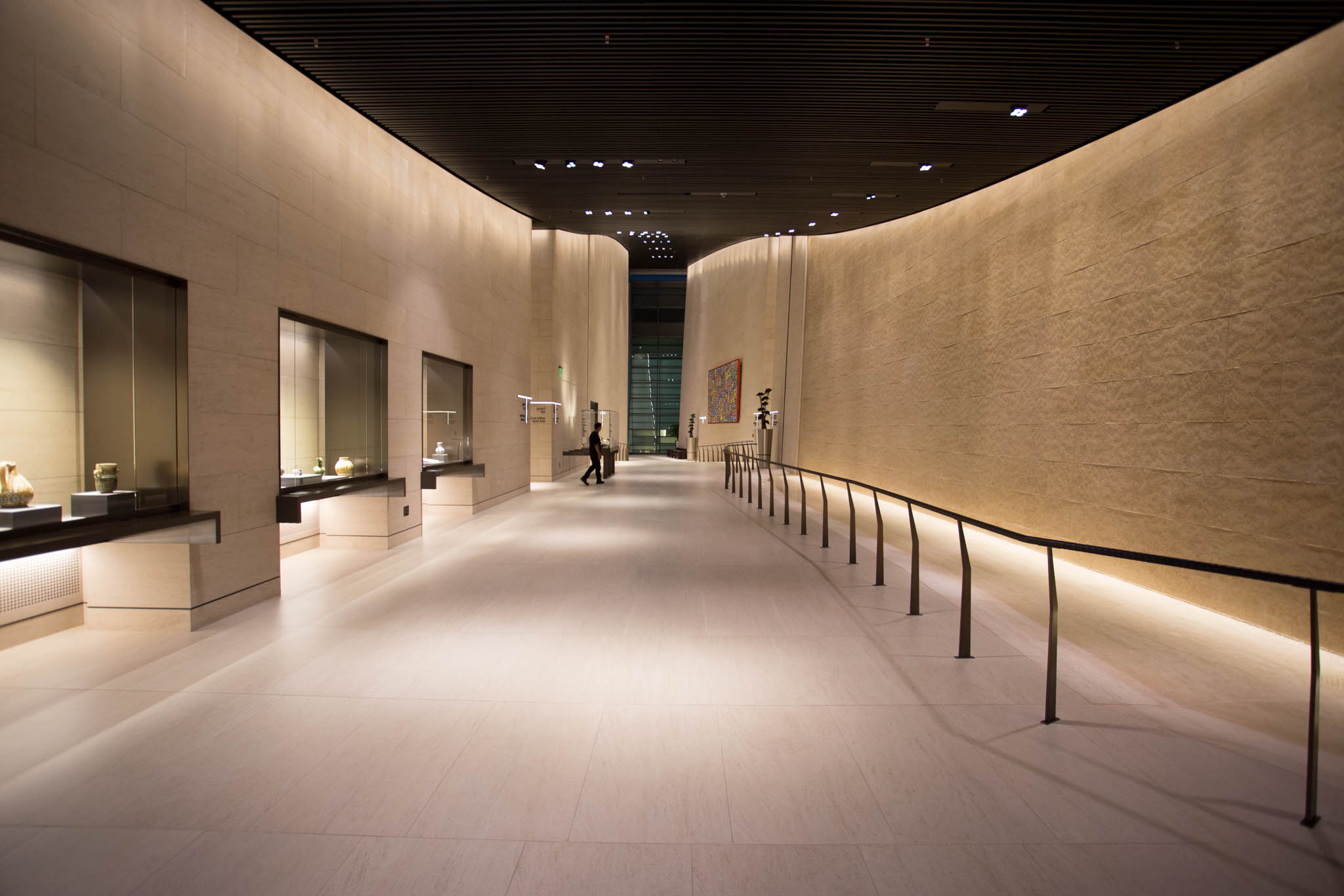 a hallway with a man walking in the middle