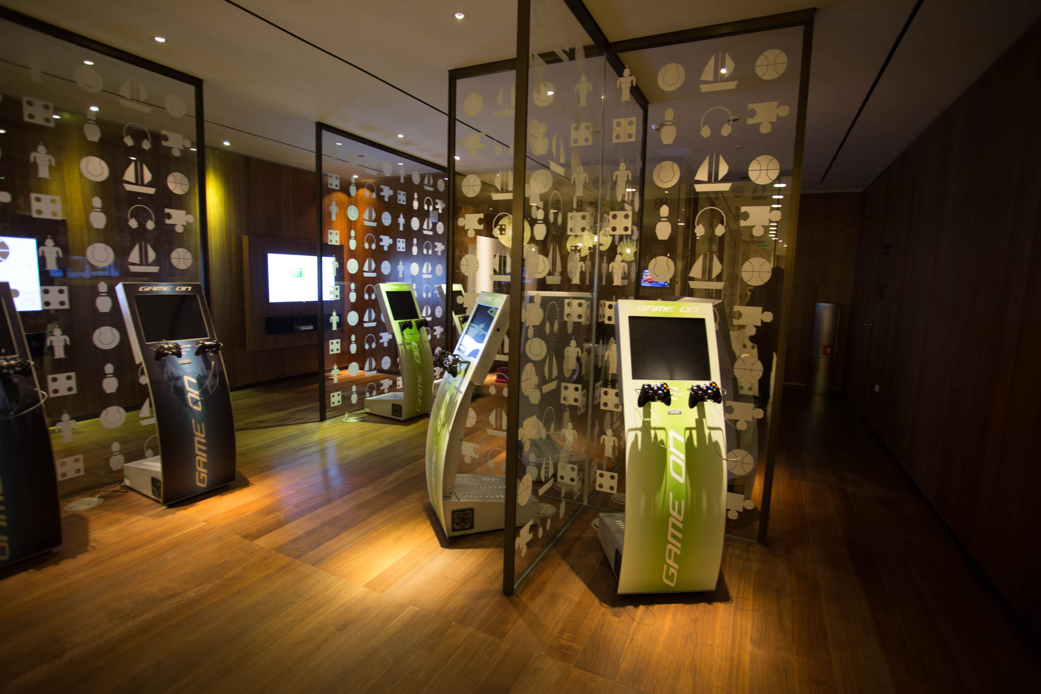 a room with arcade machines and screens