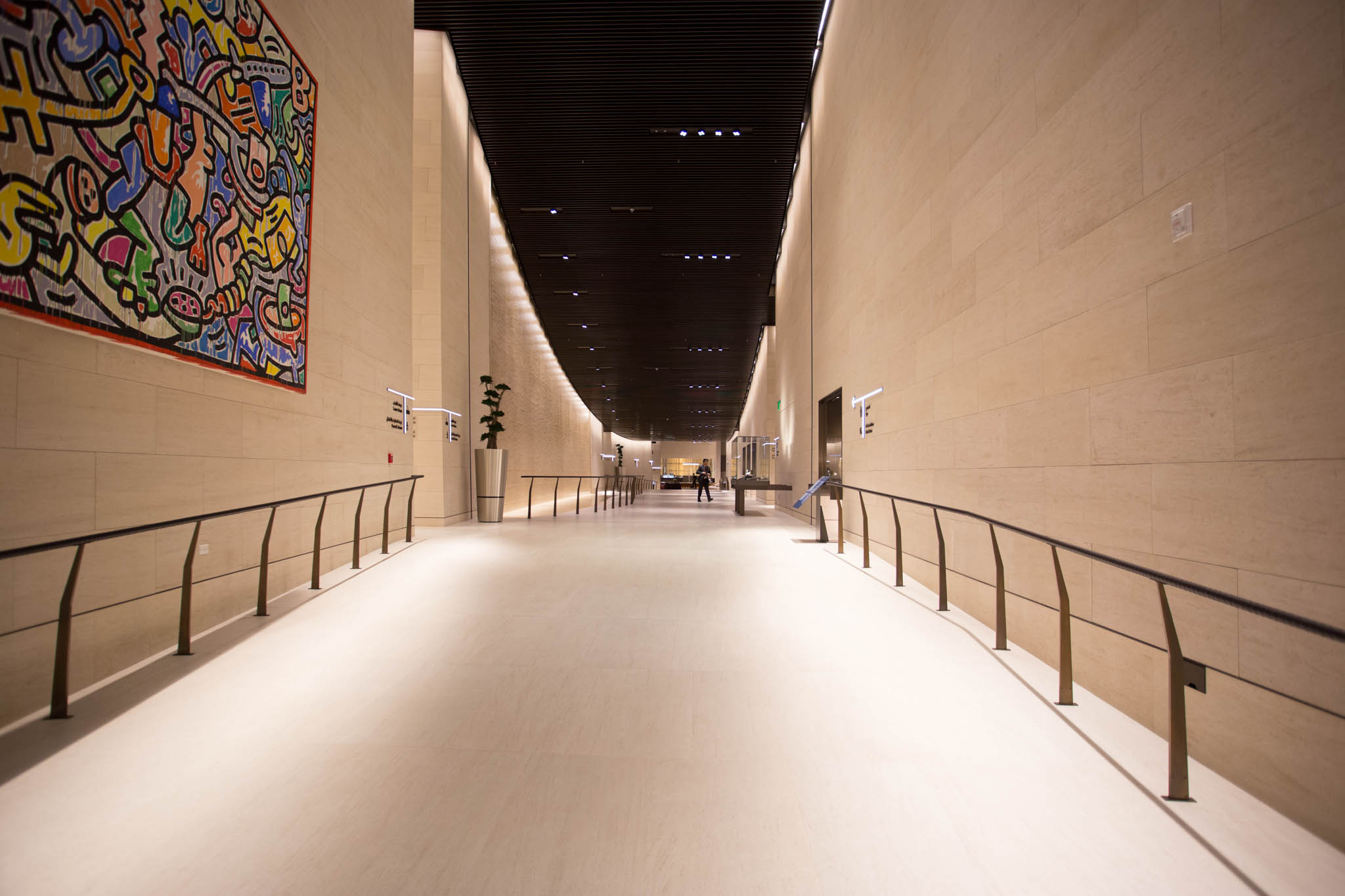 a hallway with a large wall and a painting on the wall