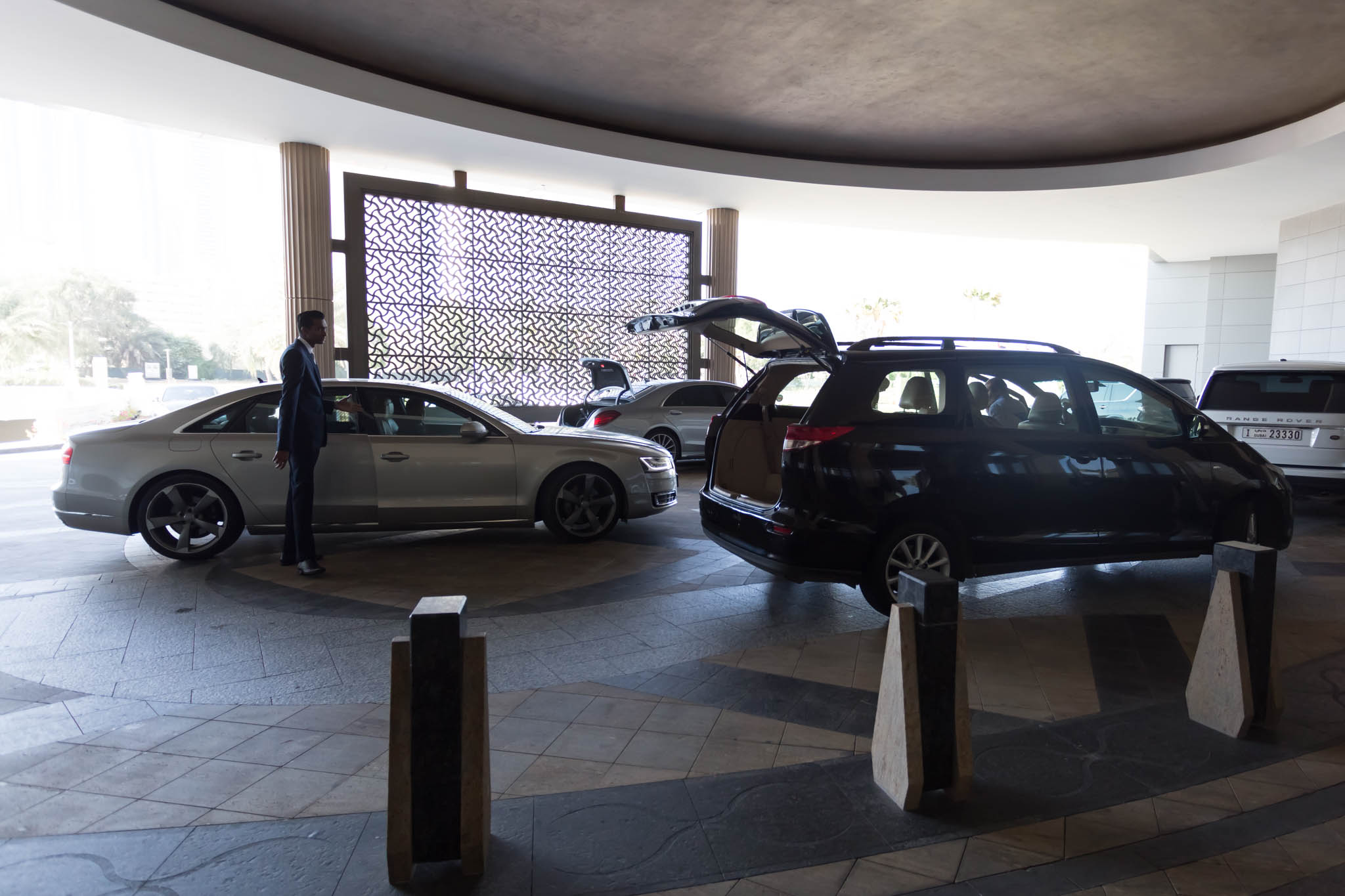 a man standing in a room with cars