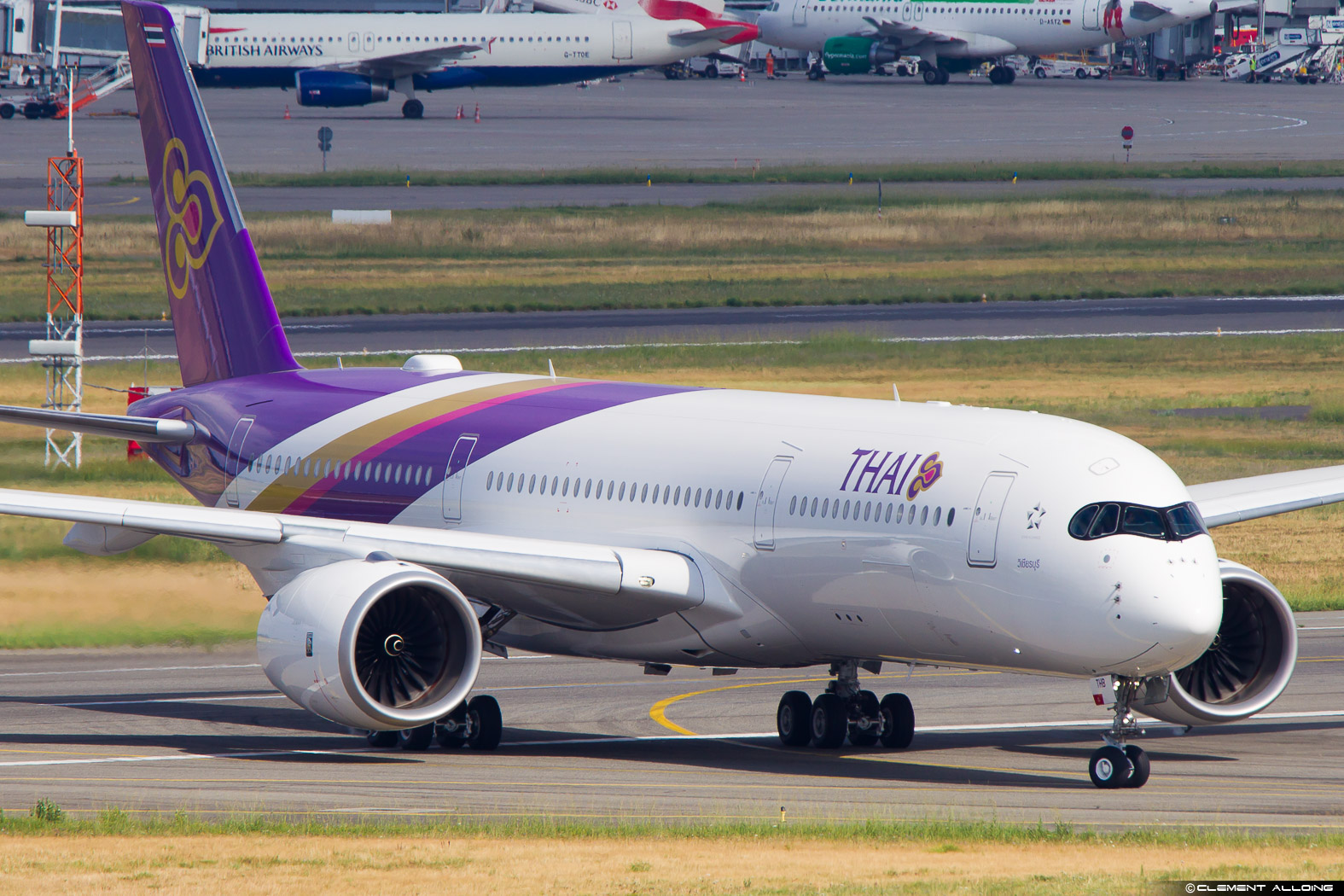 a white and purple airplane on a runway