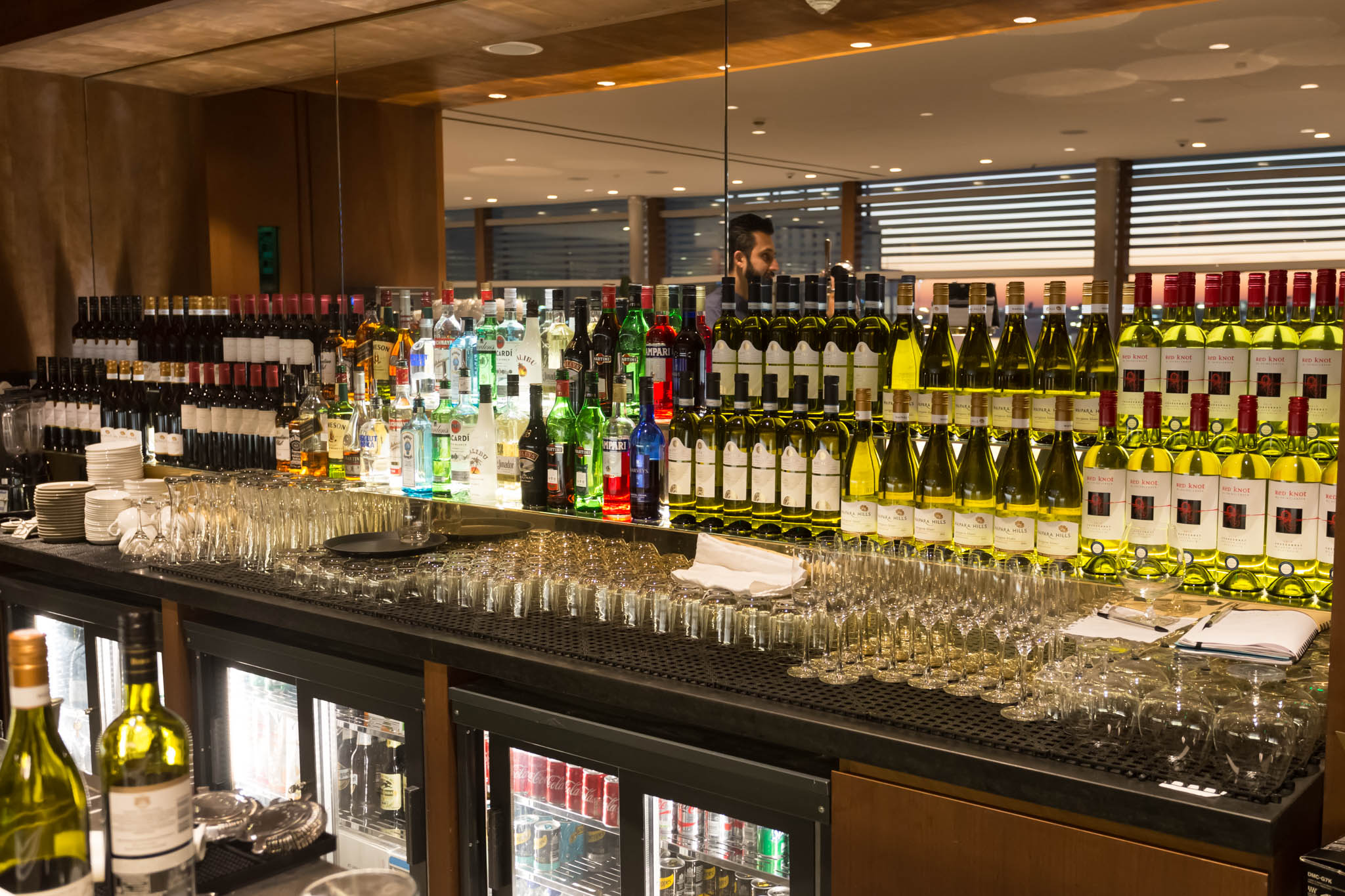 a bar with many bottles and glasses