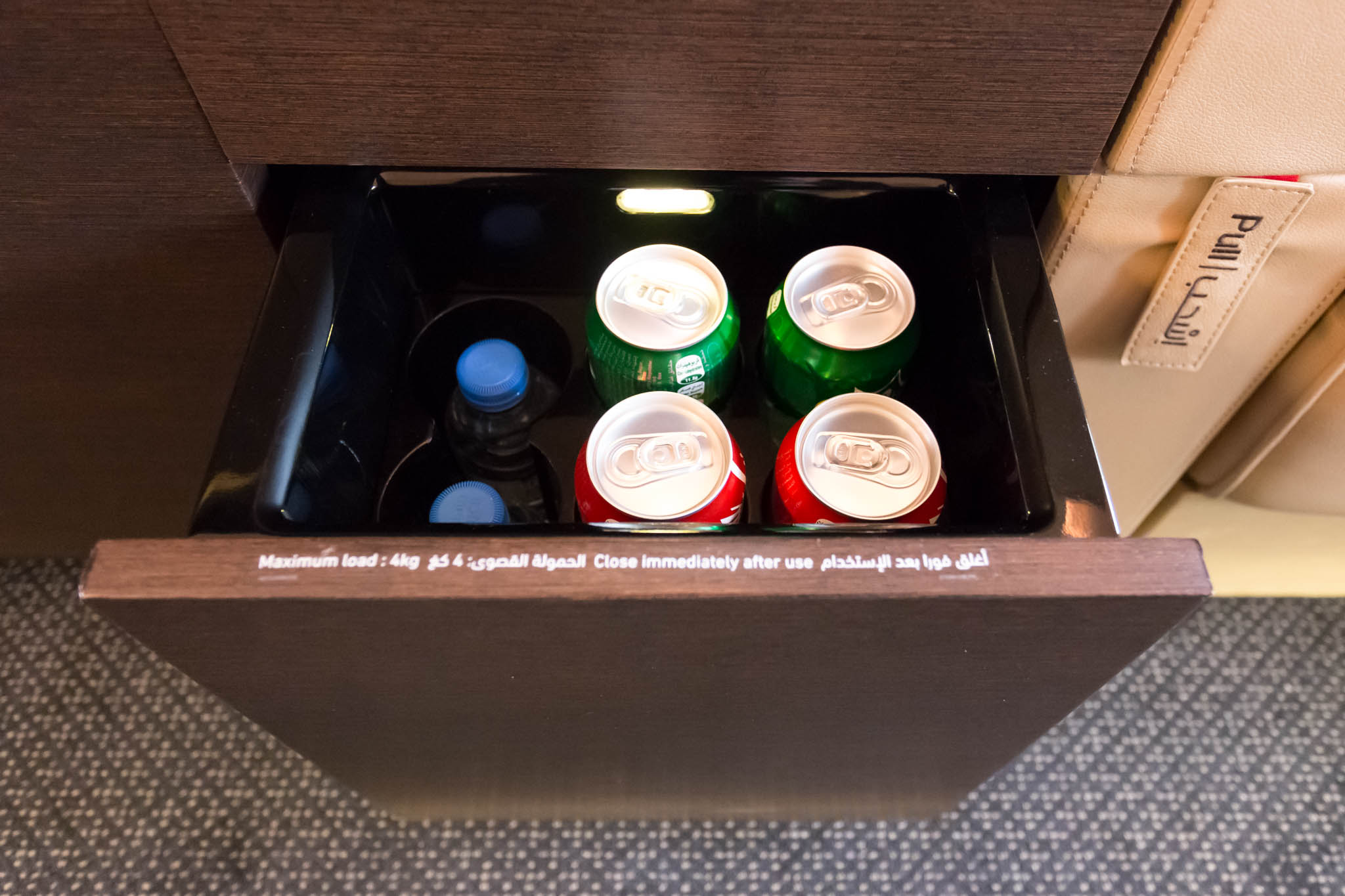 a drawer with cans and bottles inside