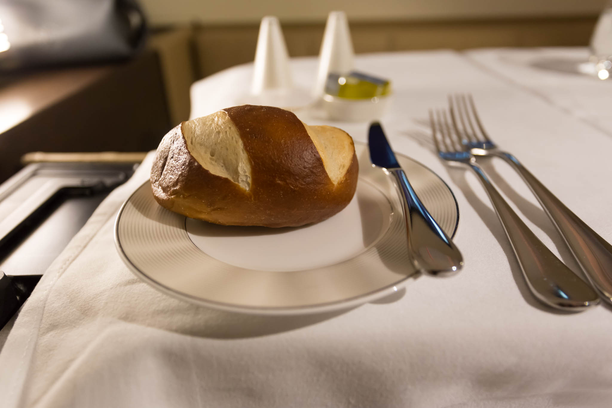 a piece of bread on a plate with a fork and knife