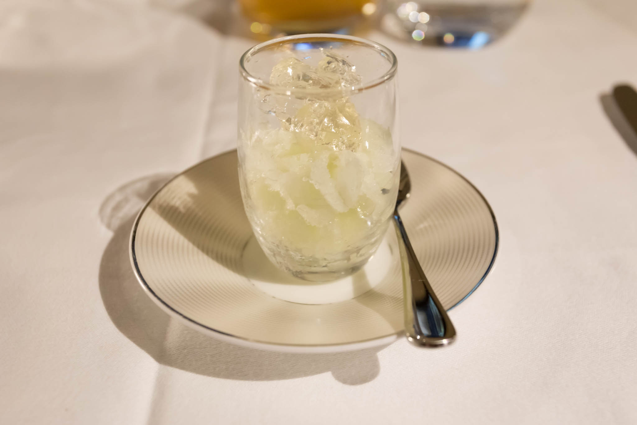 a glass with ice on a plate