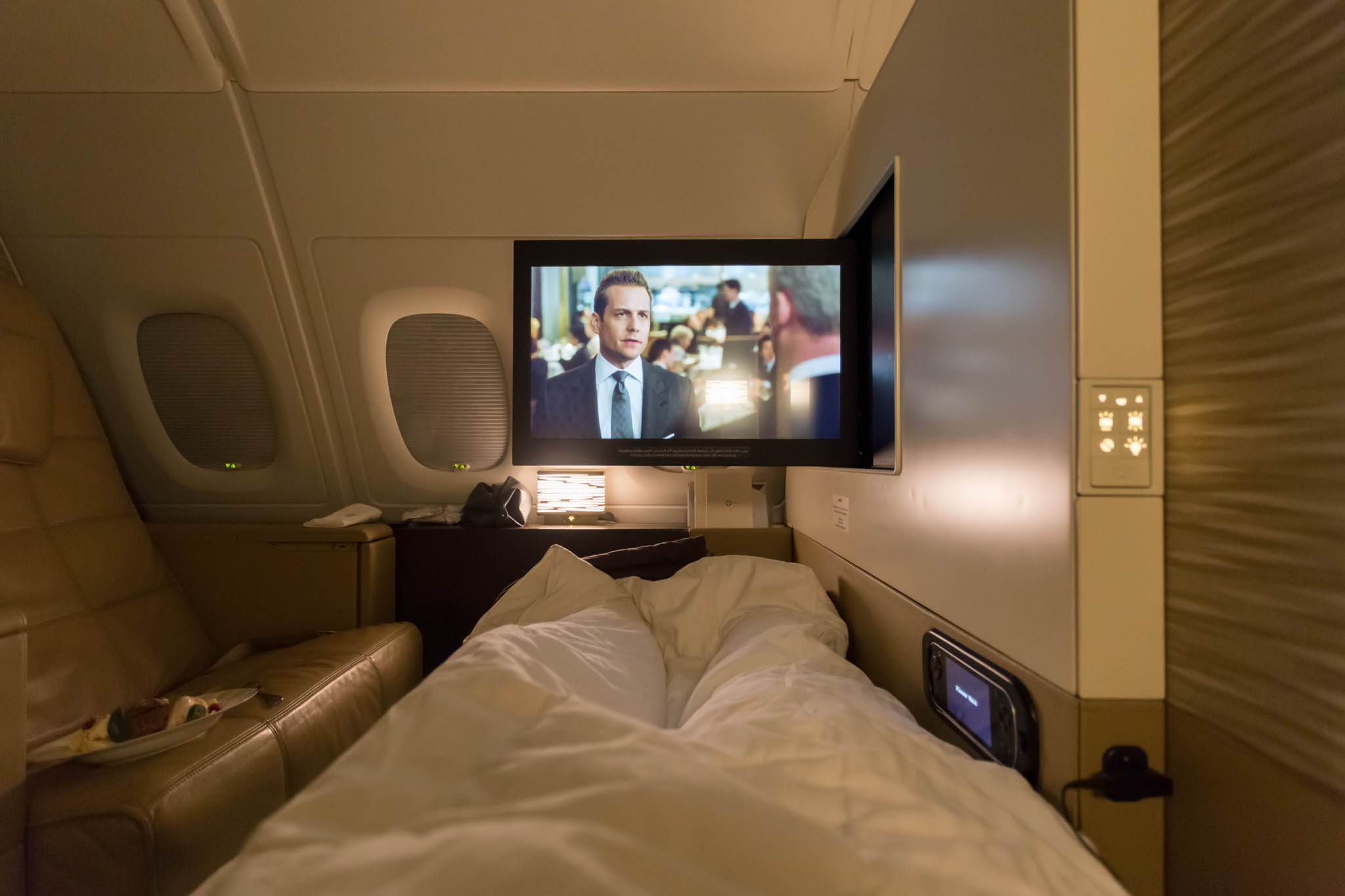 a tv on a bed in an airplane