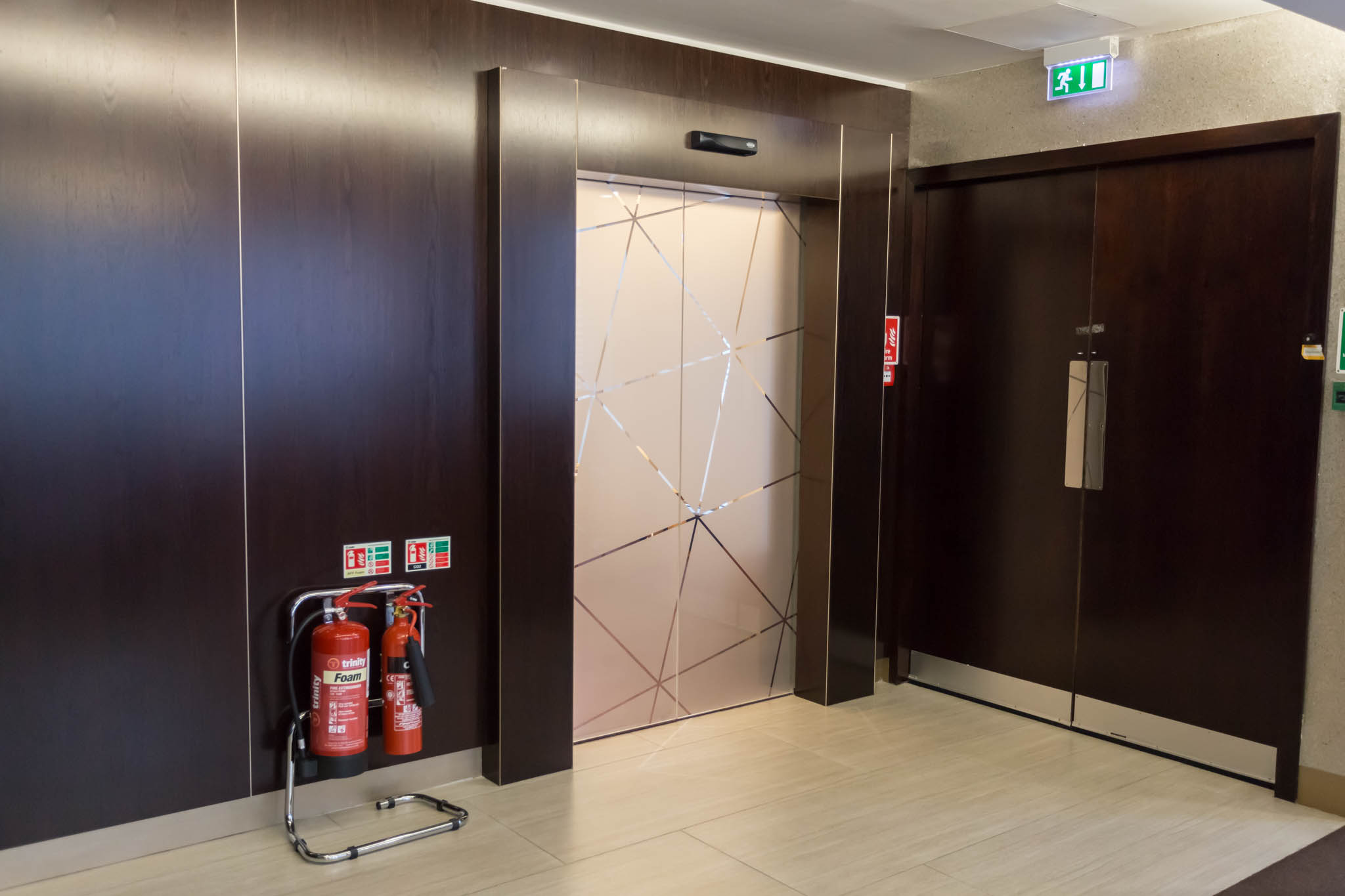 a elevator with fire extinguisher and fire extinguisher