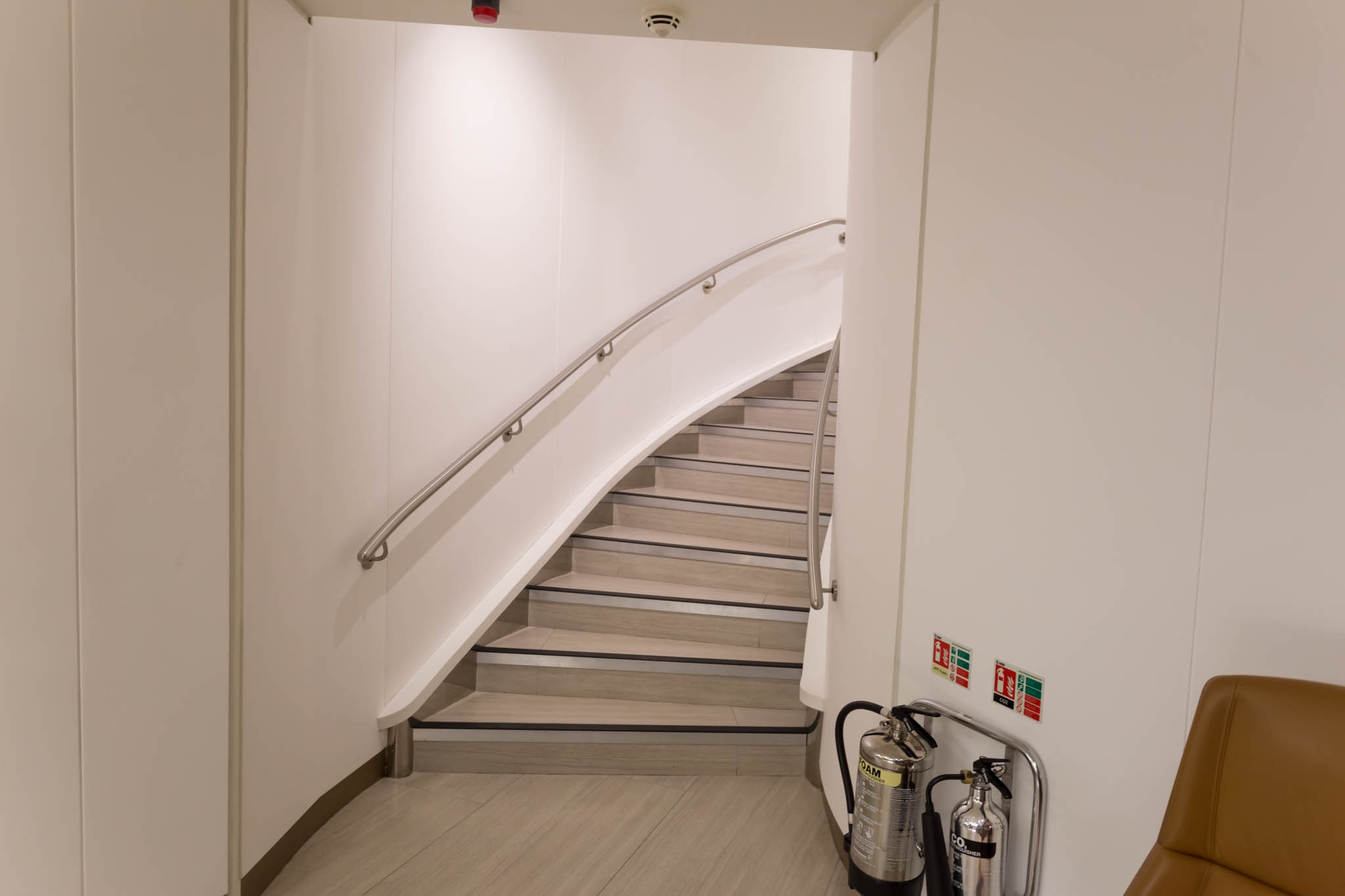 a staircase with fire extinguisher and fire extinguisher