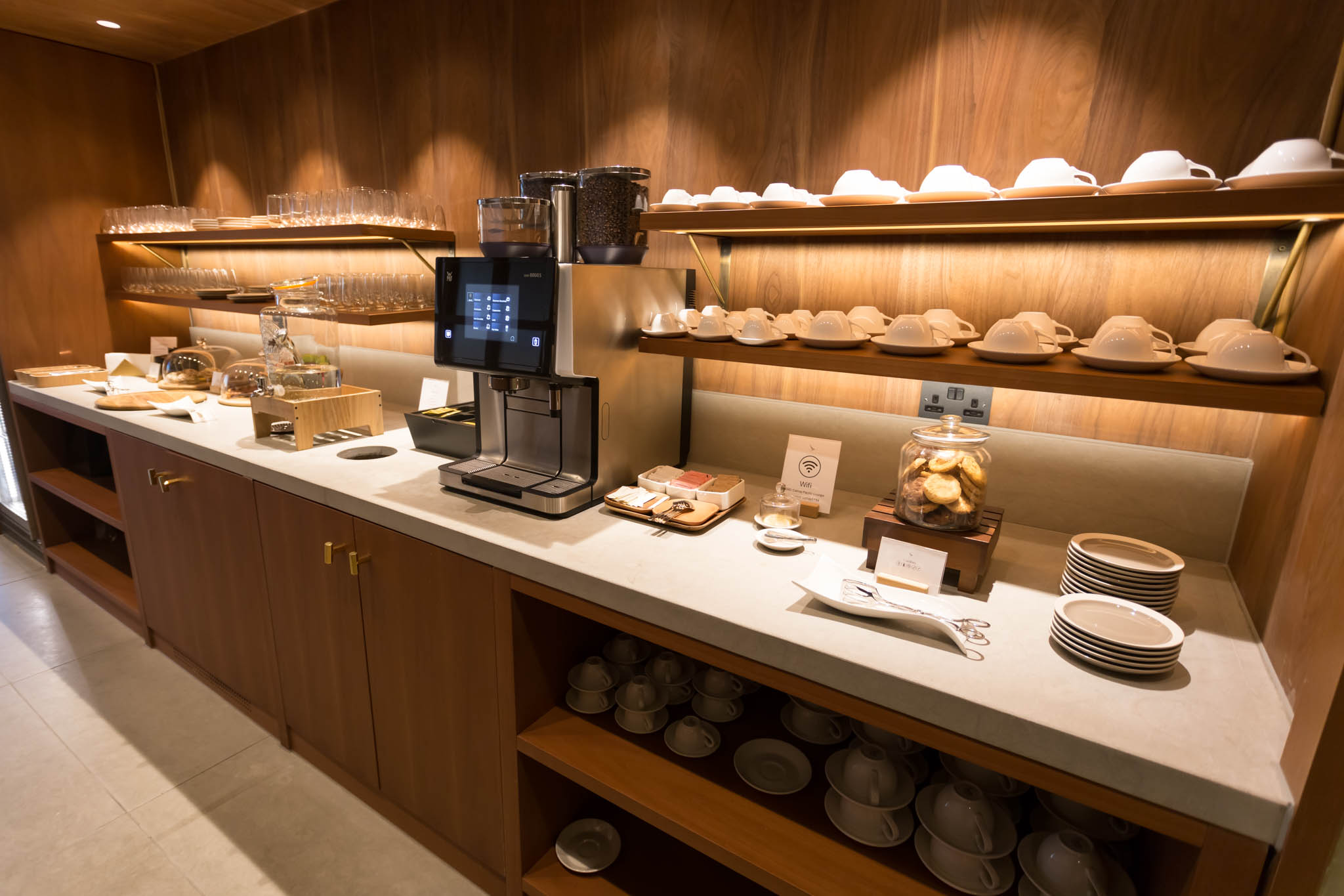 a counter with a coffee machine and plates on it