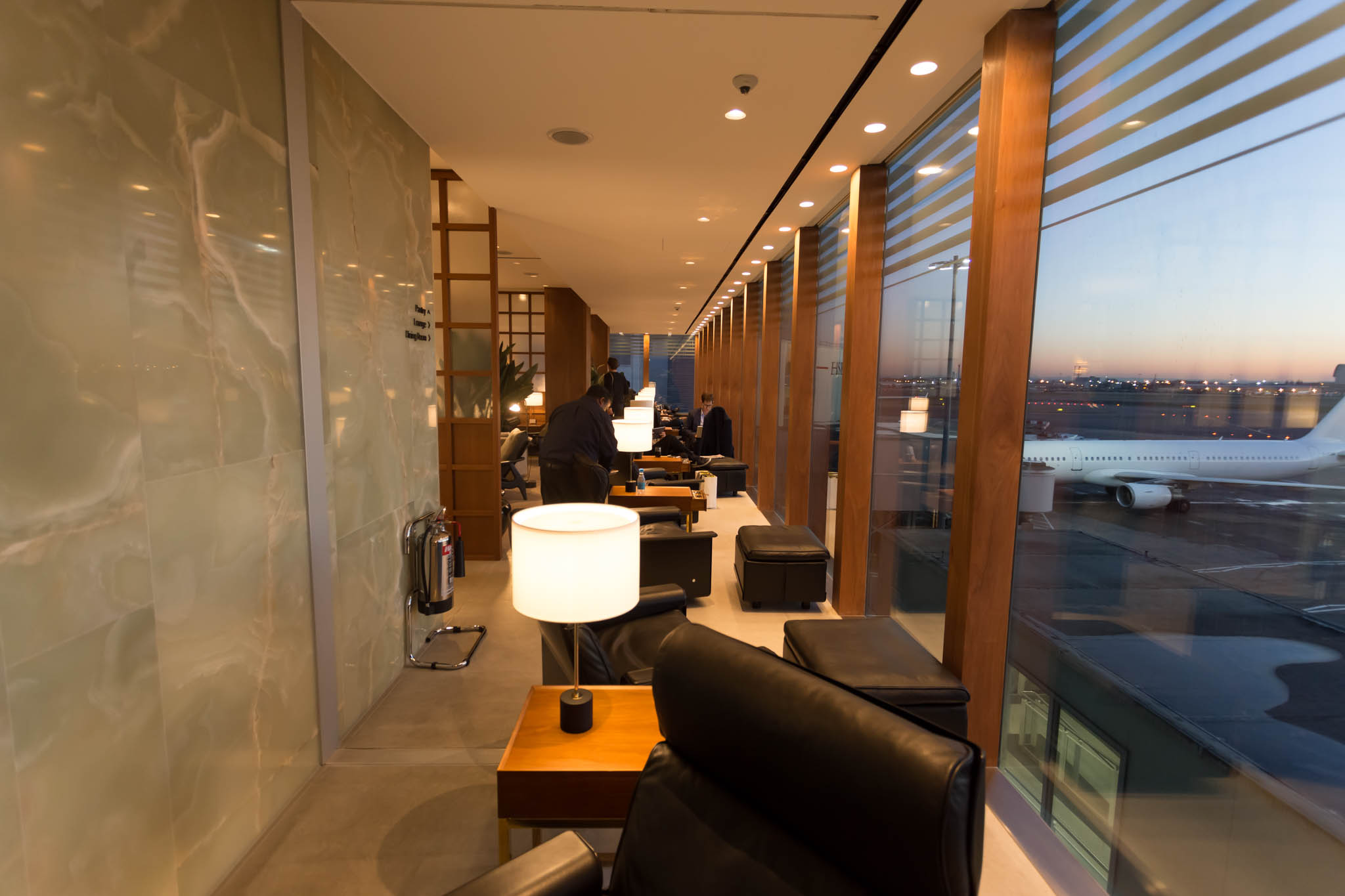 a room with a large window and chairs and tables