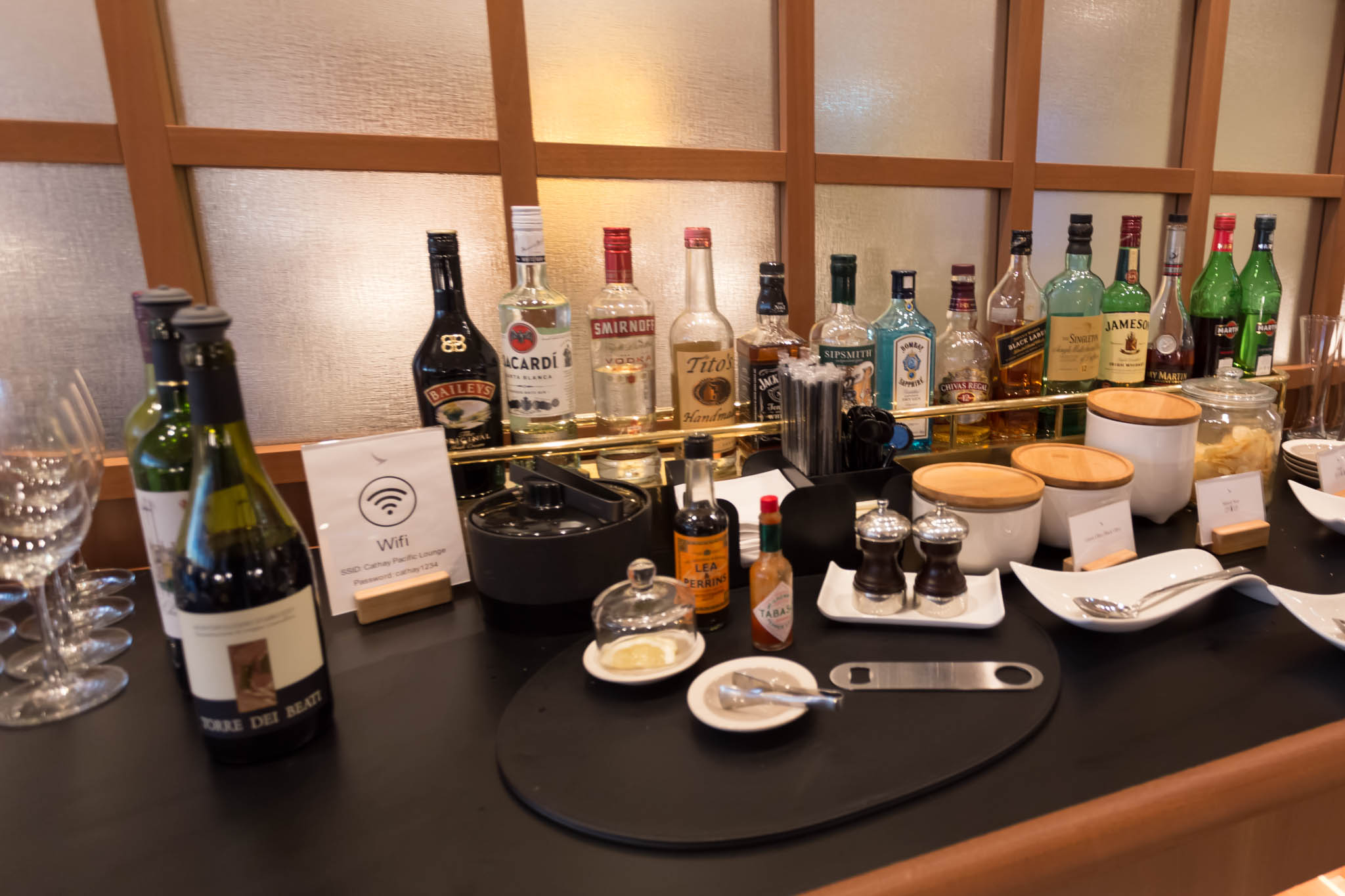 a table with bottles of alcohol and a glass wall