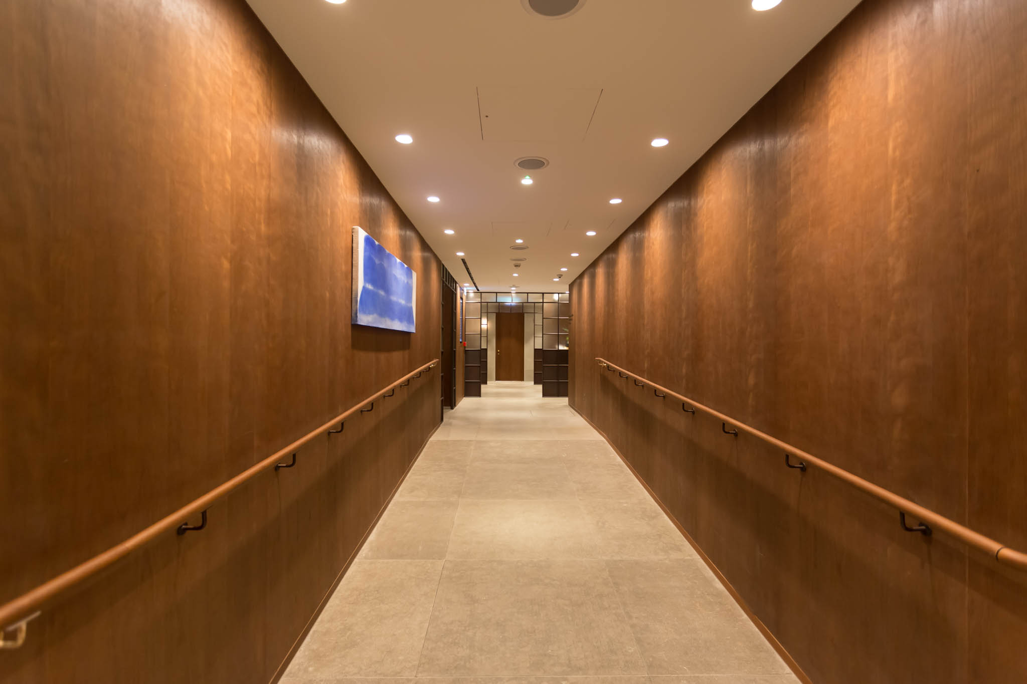 a long hallway with wood walls and lights
