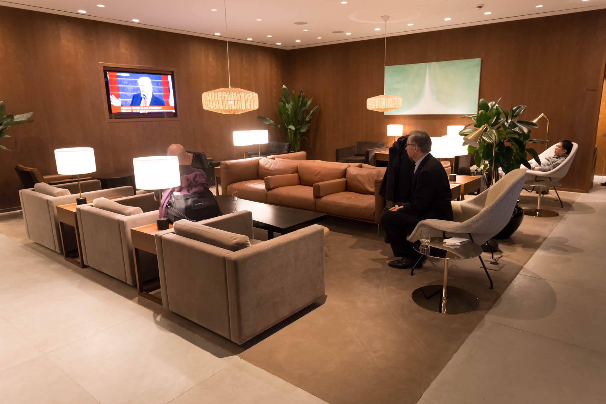 a man sitting in a room with a couch and a tv