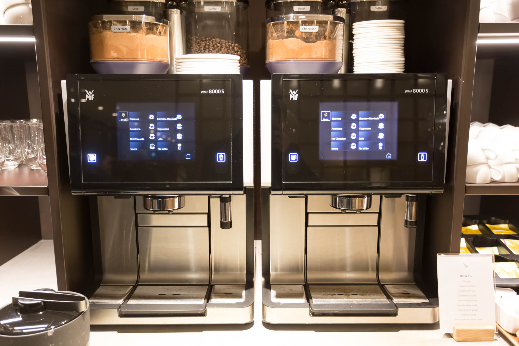 a coffee machine with containers on top of it