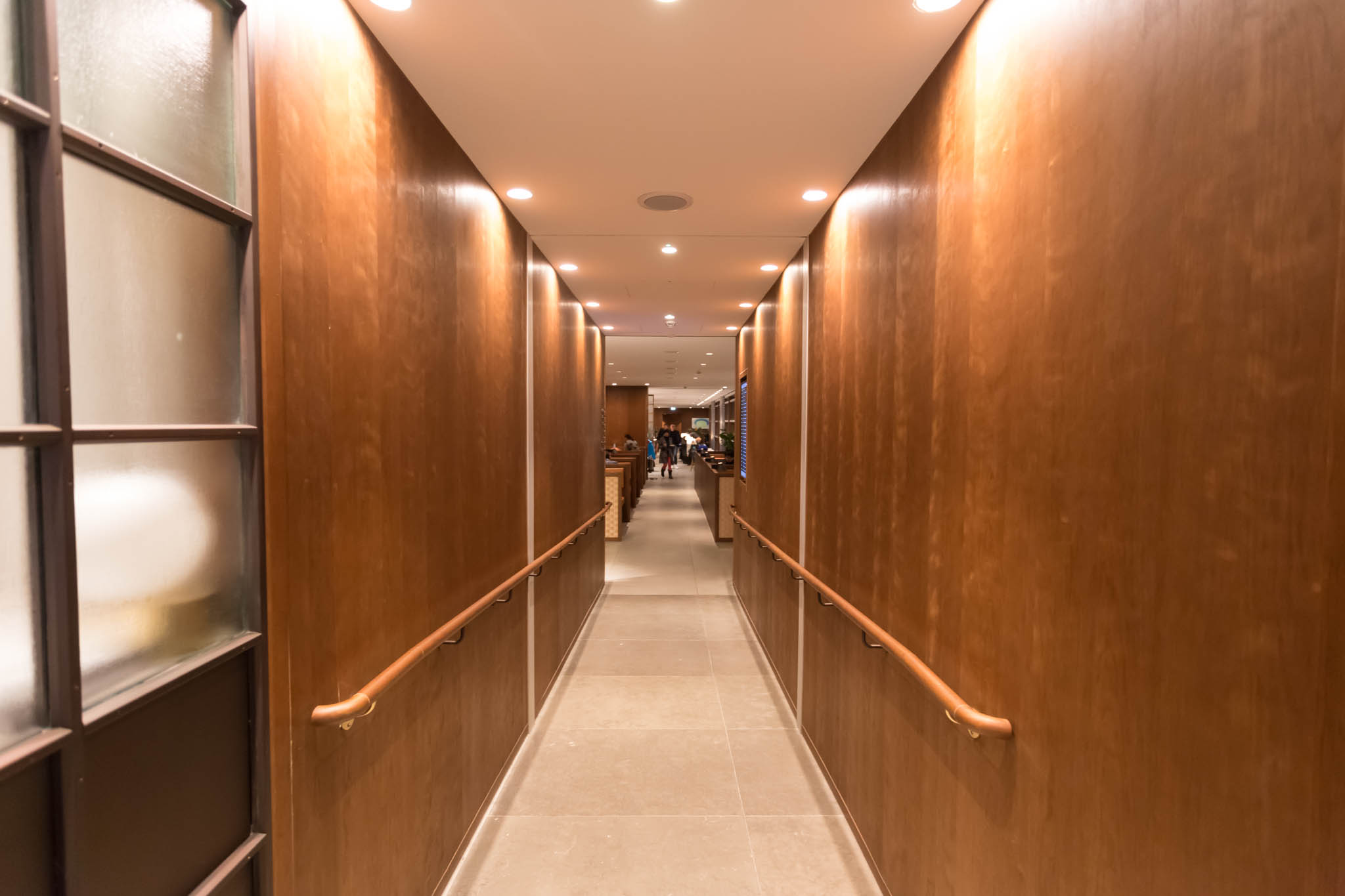 a hallway with wood walls and lights