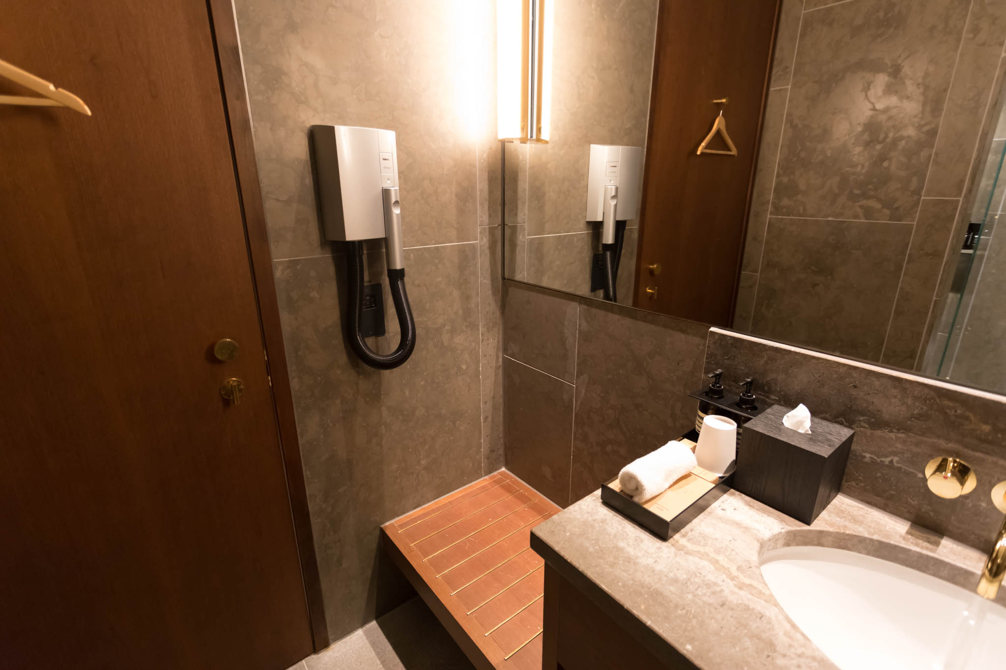 a bathroom with a mirror and a sink